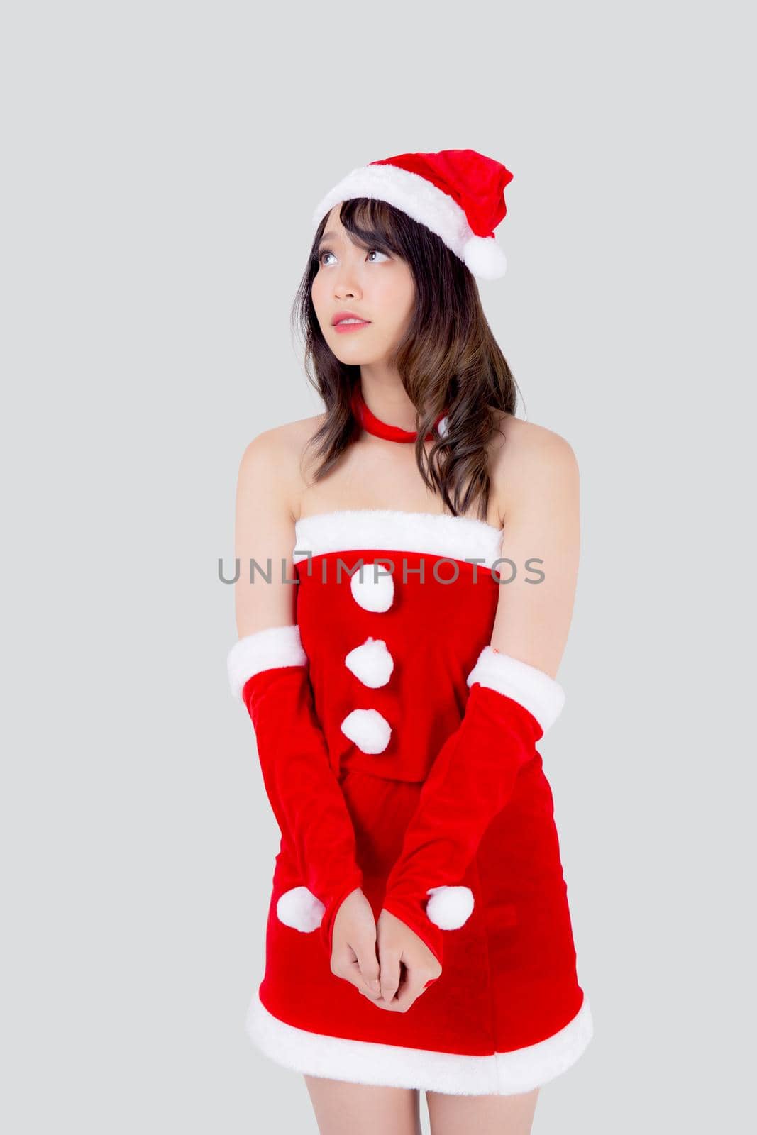 Beautiful portrait young asian woman Santa costume wear hat smiling and thinking in holiday xmas, beauty model asia girl cheerful and happiness celebrating in Christmas isolated on white background.