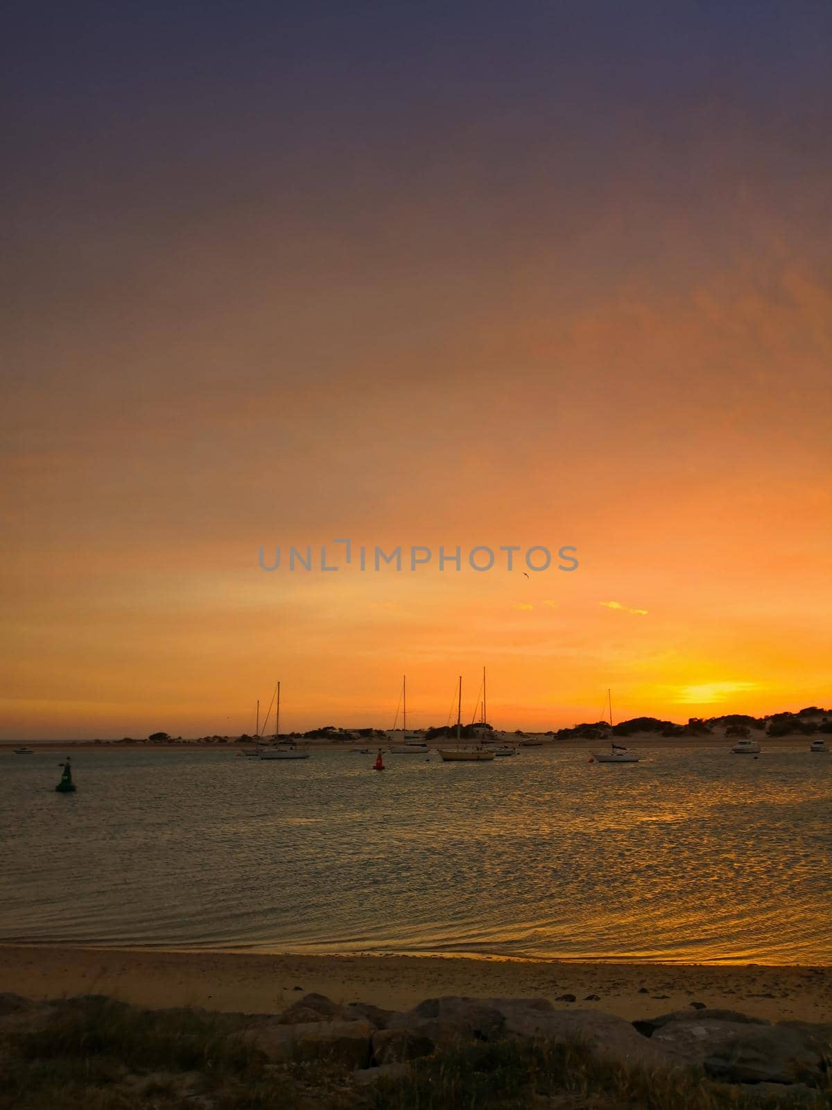 Sunset on the big bay and small sailboats, seashore, spring, Spain