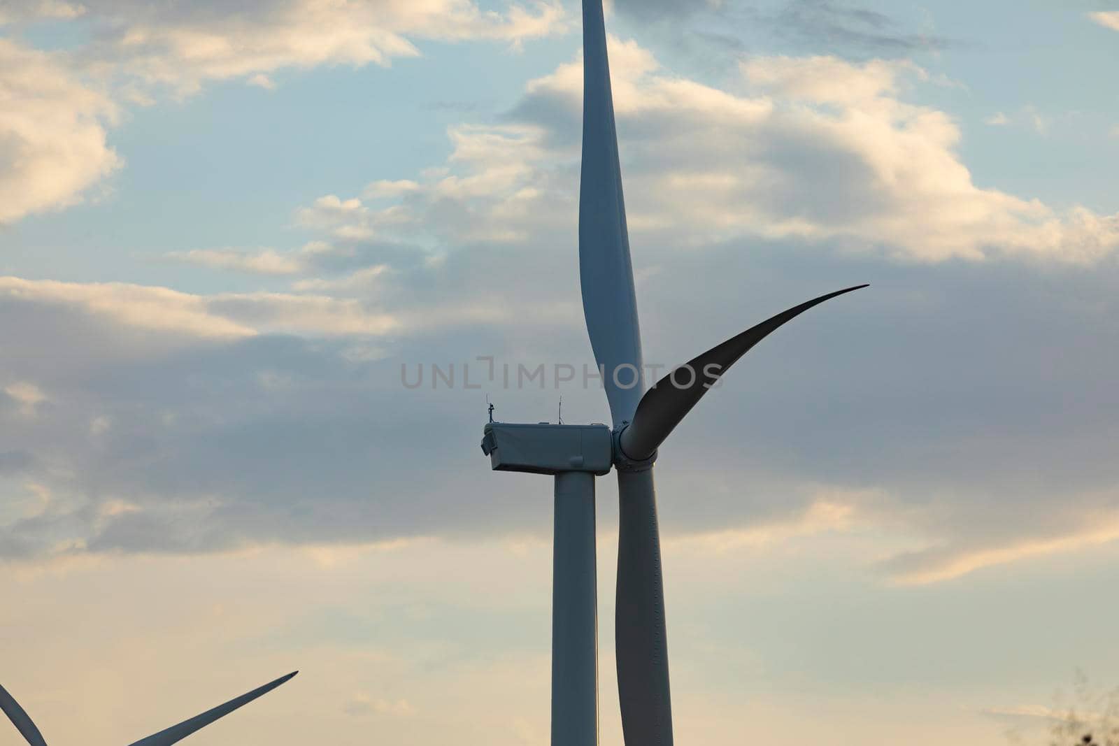New wind turbine, recently installed in north of Spain, rotates with the wind at sunset, community of Aragon.