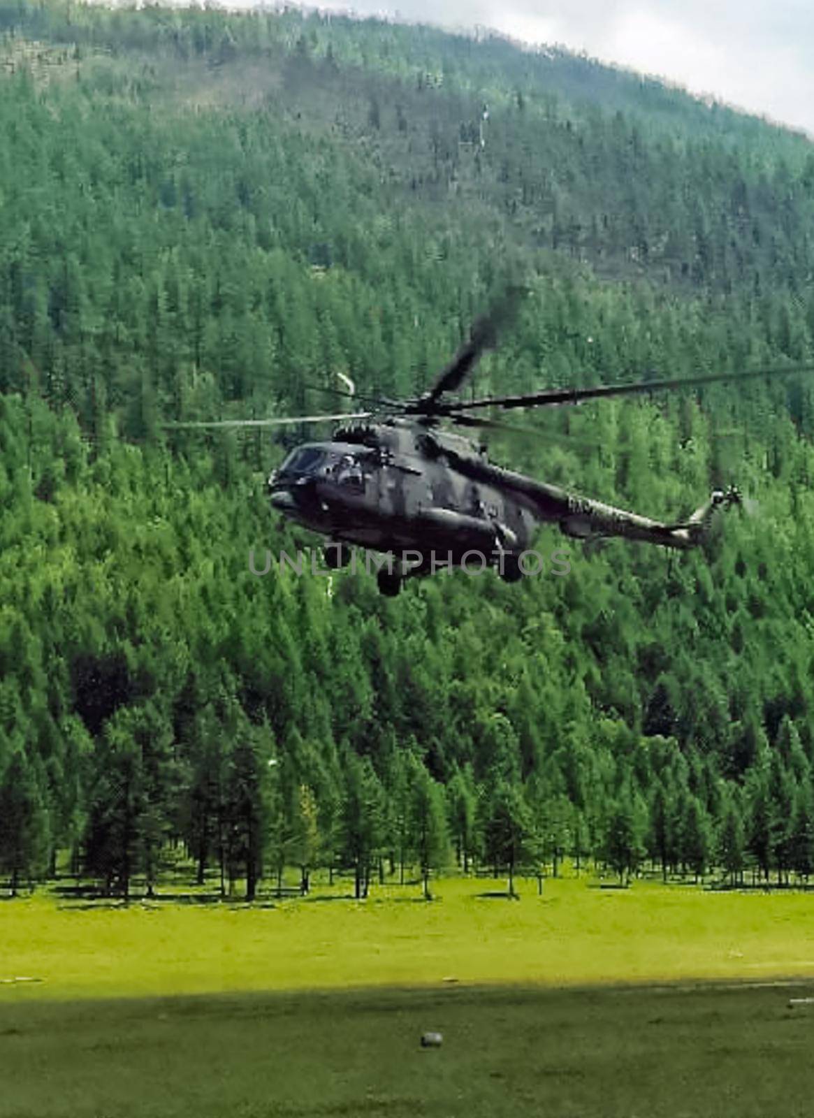 Helicopter MI-8 lands on edge in the woods in mountains. by DePo