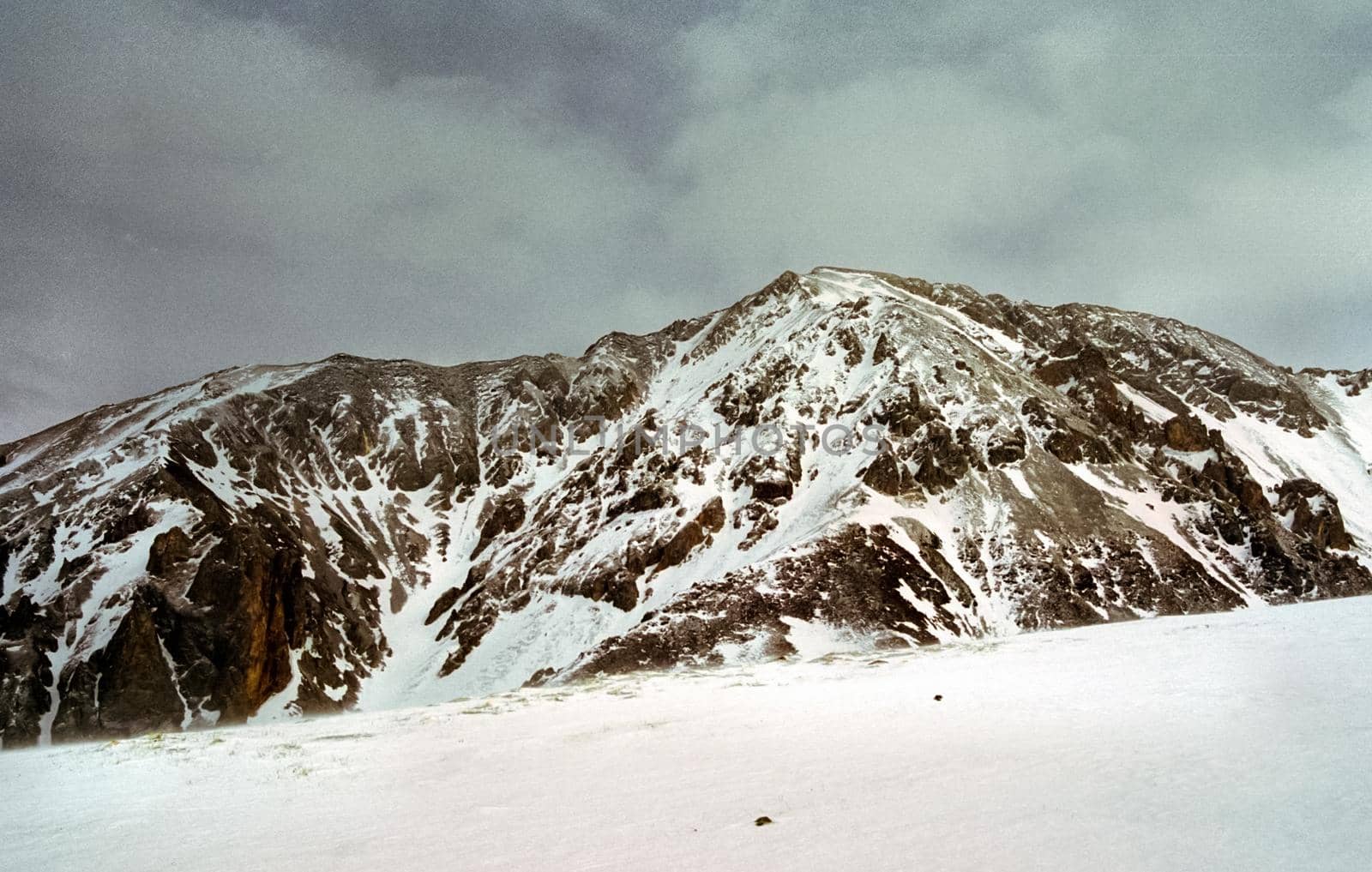 Mount Sayan in winter in the snow. The nature of the mountains is sayan.