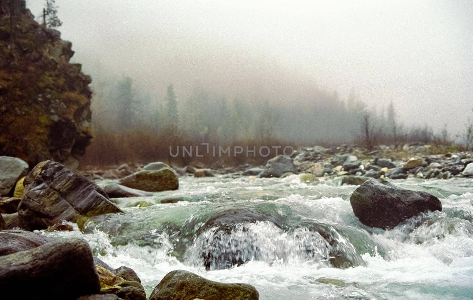 Mountain river. Stones and water of a mountain river. The mountains are said.