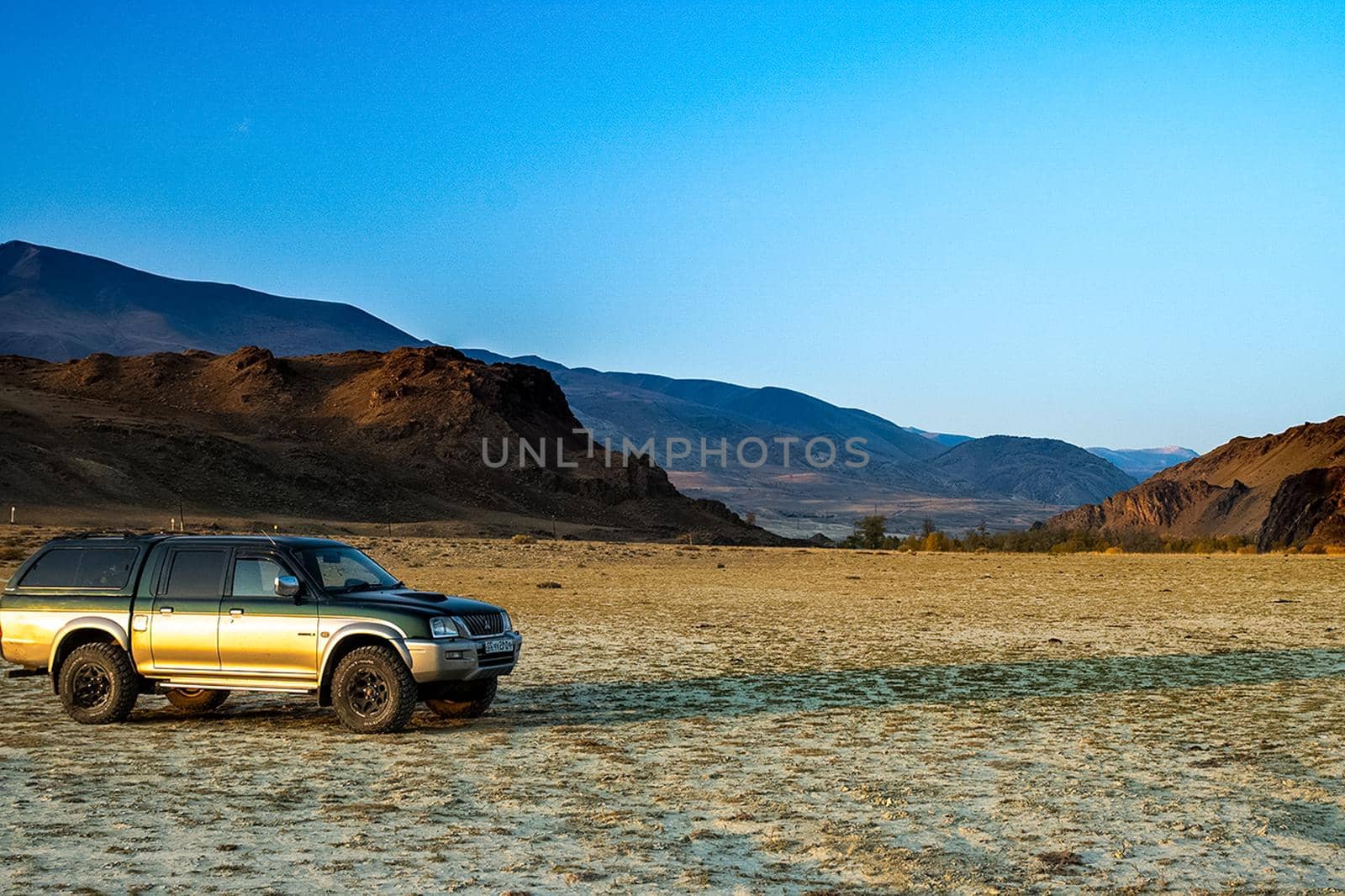 SUV against the background of mountain landscape. Travelling in an SUV by DePo