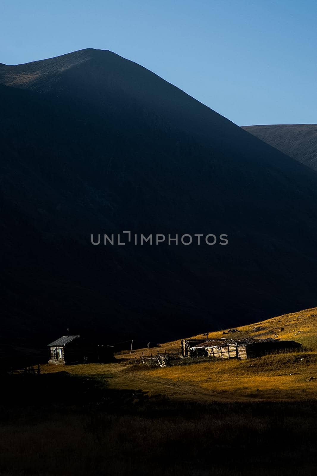 wooden house on a hill in the altai at the foot of the high mountains. by DePo