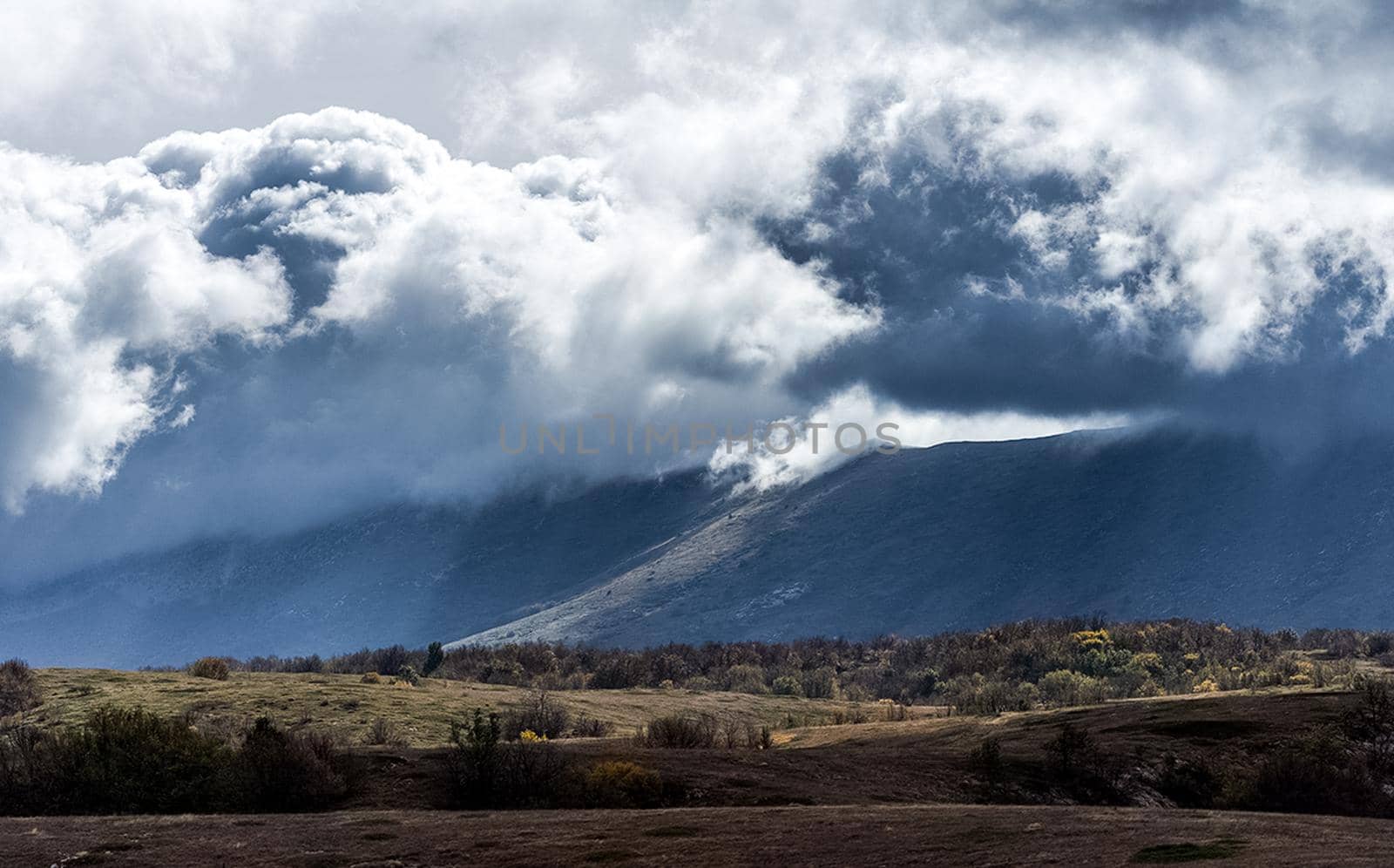 beautiful clouds over mountains of Crimea. Morning sun above the clouds.