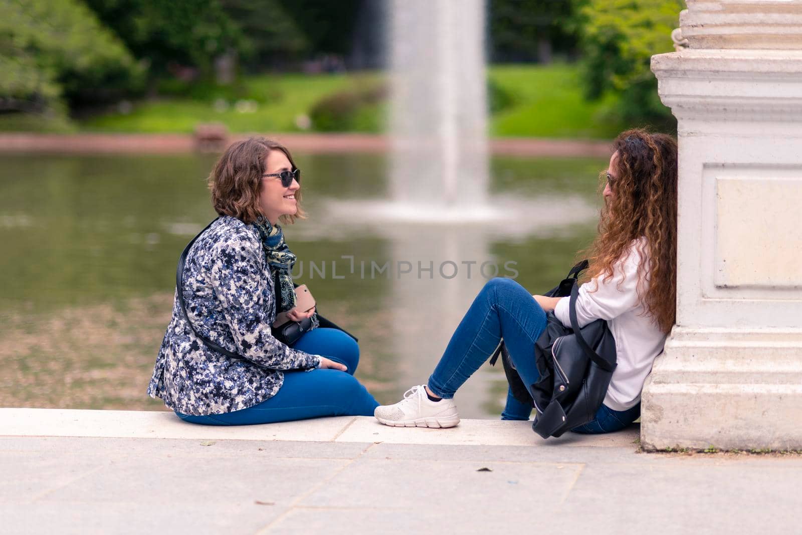 Mother and daughter talking sitting by cabrera