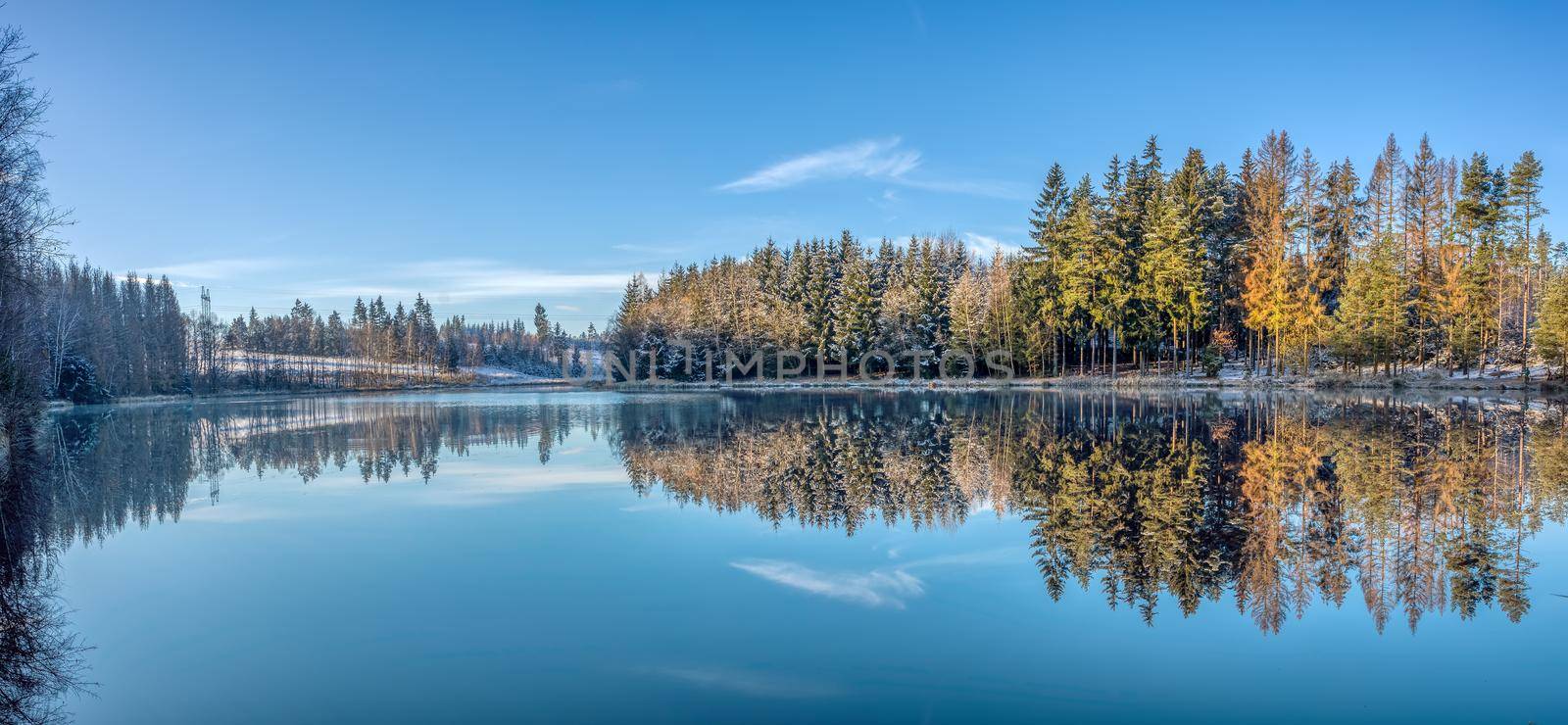 Beautiful Reflections of trees covered by snow in Lake by artush