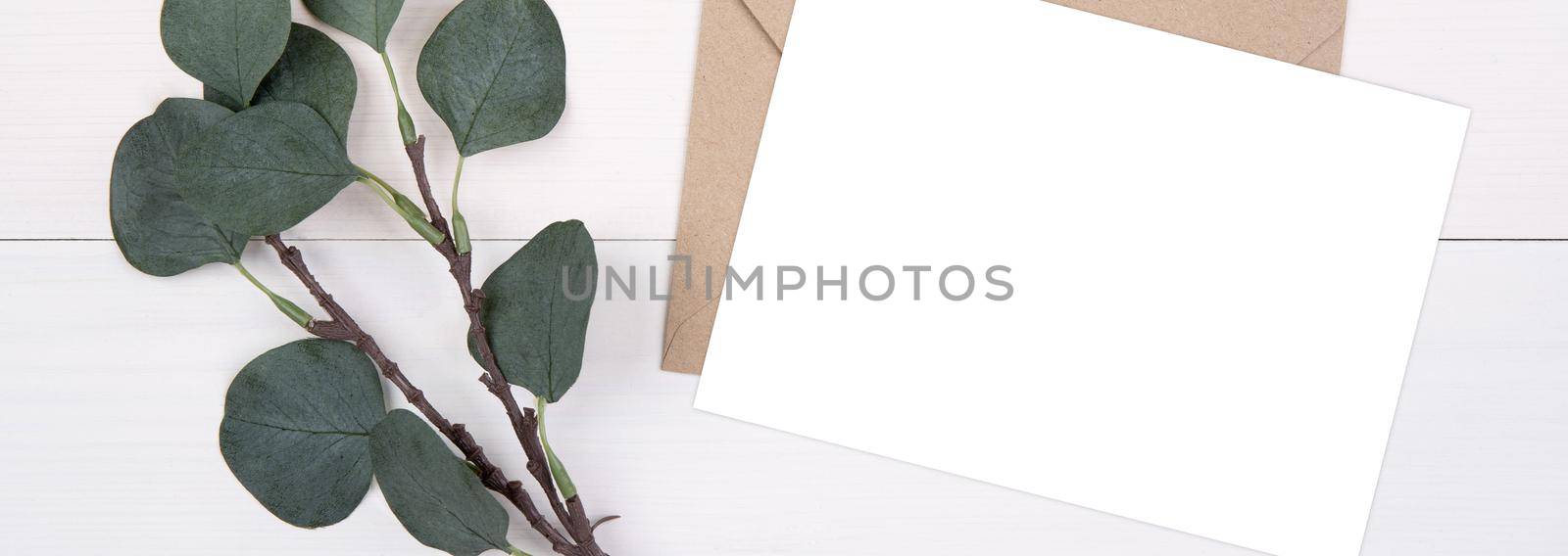 Blank paper sheet copy space with mockup and leaf on wooden table, card, poster and envelope, postcard decoration your design or branding, simplicity and minimal, flat lay, top view, banner website.