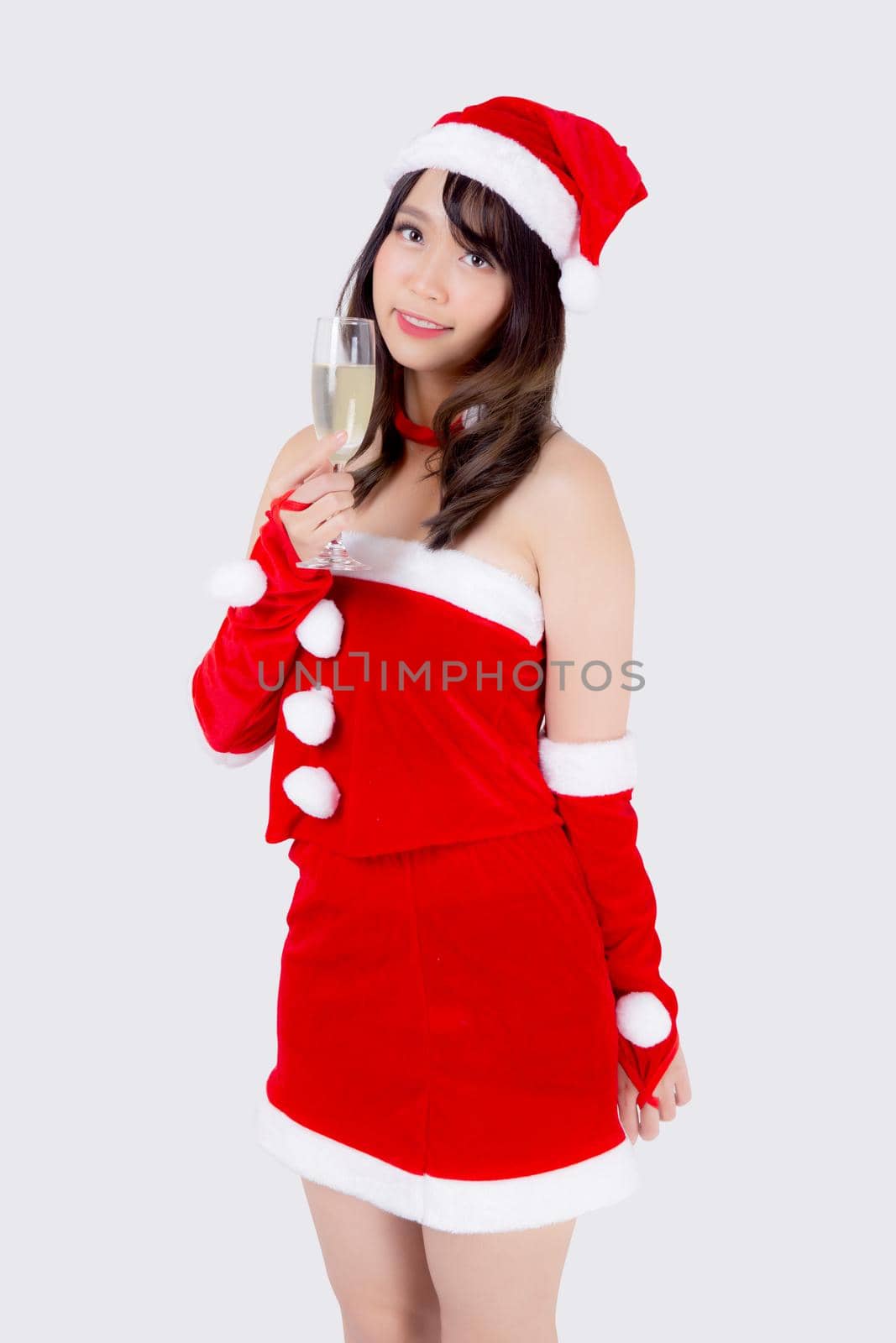Beautiful portrait young asian woman in Santa holding glass of champagne with party celebrating in xmas holiday isolated on white background, asia girl drink beverage, Christmas and new year concept. by nnudoo
