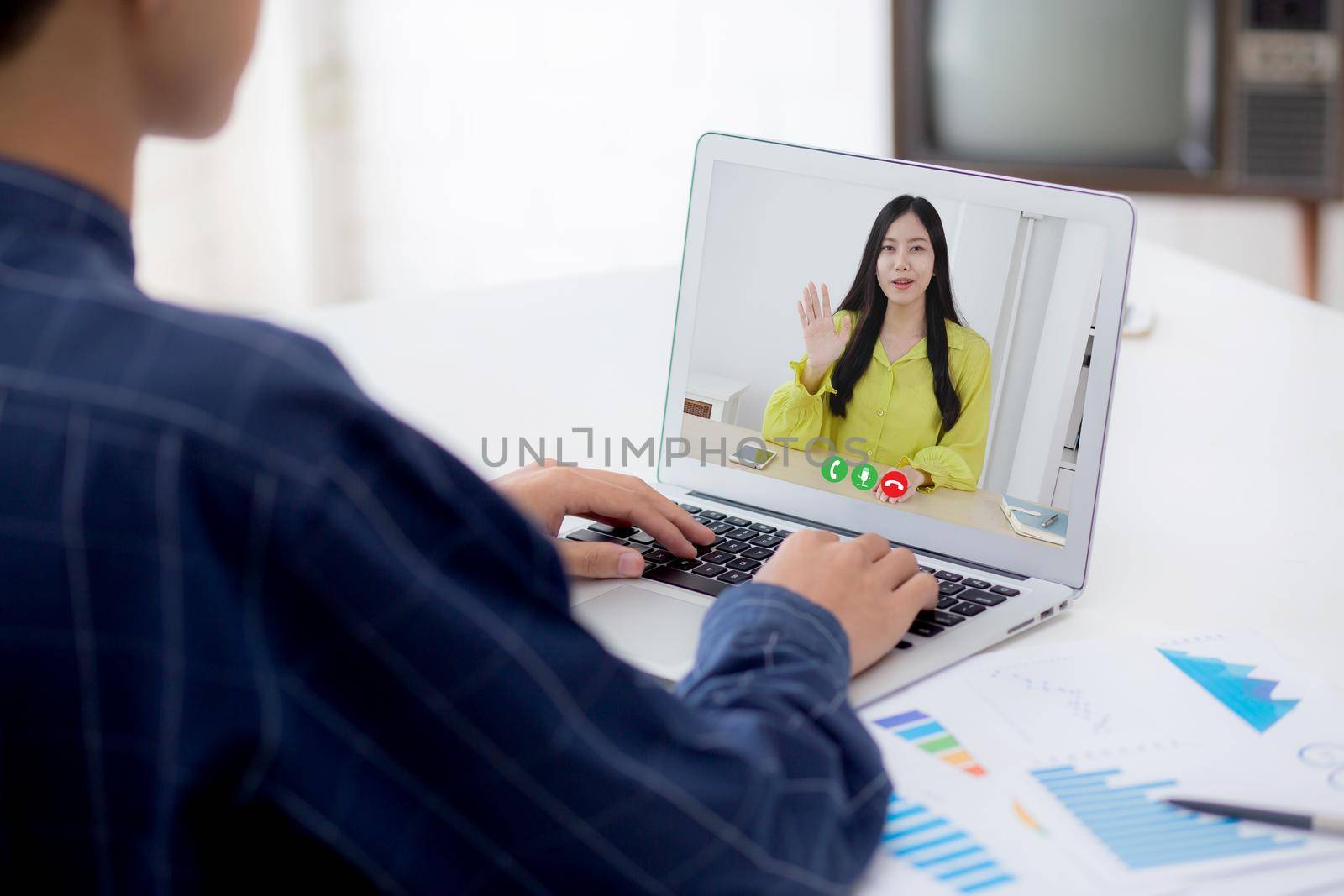 Young asian business man working laptop computer blank display screen while report graph and chart paper on desk, businessman analysis statistic of finance on table, planning for success, indoor.