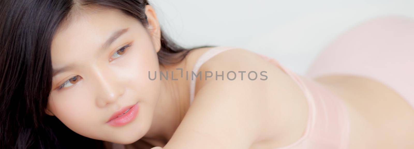 Beautiful young asian woman sexy in underwear figure fit relax in bedroom, asia girl body slim in lingerie confident and happy lying on bed in bedchamber, lifestyle concept, banner website.
 by nnudoo