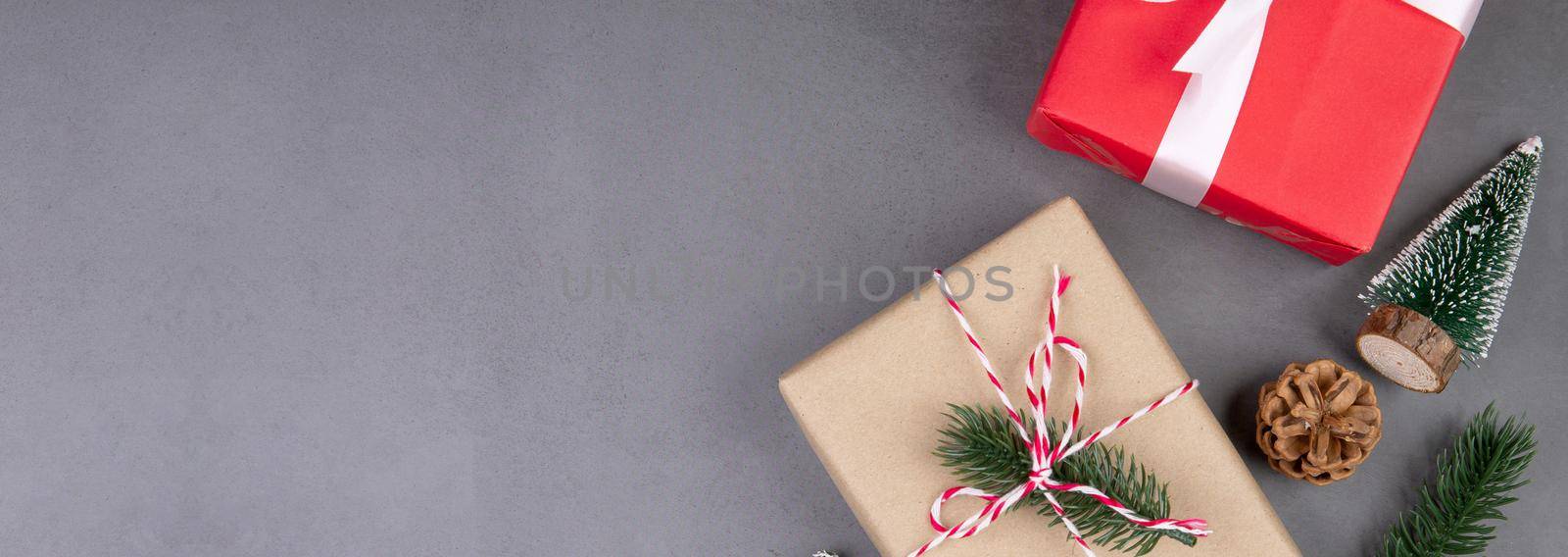 Christmas holiday composition with red gift box decoration on cement floor background, new year and xmas with presents on concrete in season, top view or flat lay, copy space, banner website.