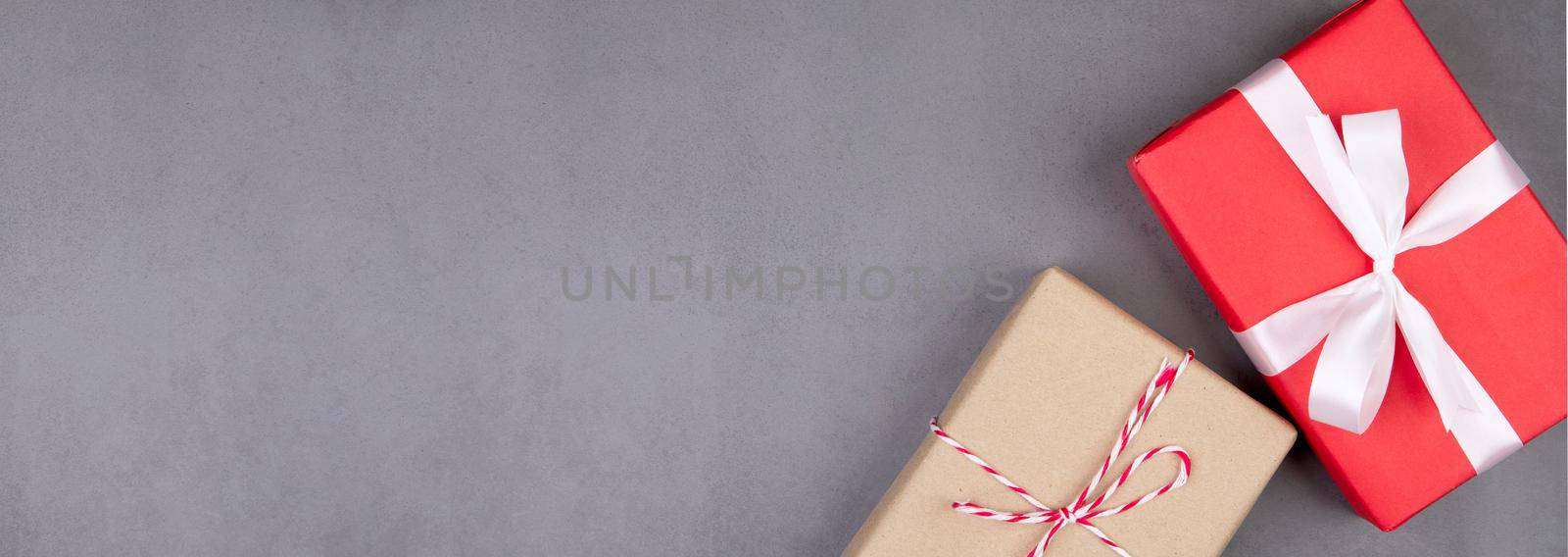 Red gift box on cement floor in Christmas day or holiday, present box on desk, anniversary or celebration with copy space, celebrate and festive, top view, flat lay, nobody, banner website.