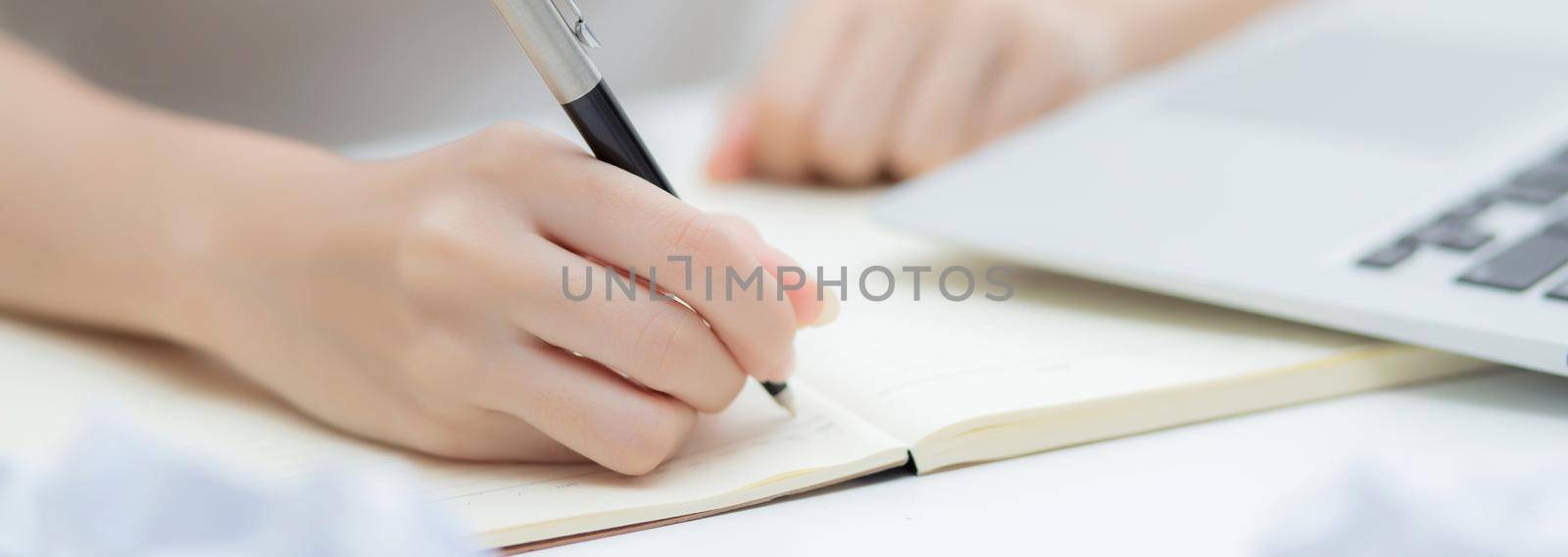 Closeup hand of young asian woman work and writing for planning on notebook on table at home, girl thinking idea and creative, finance and communication, freelance and business concept.