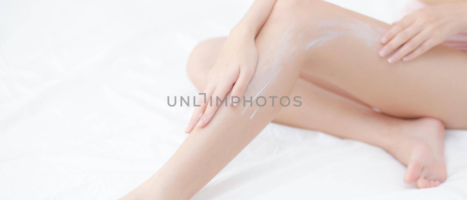 Young asian woman touch skin leg smooth with cream and lotion for hydration and smooth, girl applying body care and cosmetic for silky, beauty perfect with wellness, health and care, banner website.