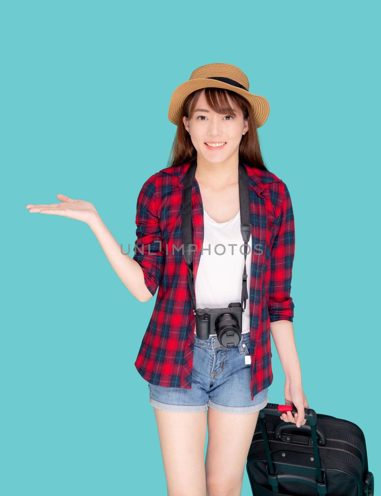 Beautiful young asian woman smiling and travel summer trip with luggage and presenting show something for abroad in vacation, asia girl having camera walking and pull suitcase for journey in holiday. by nnudoo
