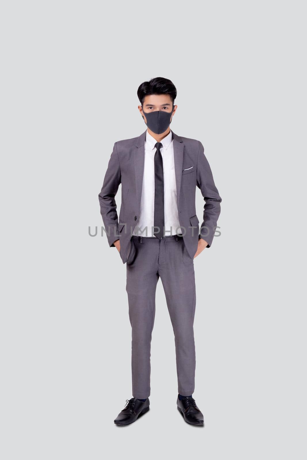 Portrait young asian businessman in suit wearing face mask for protective covid-19 isolated on white background, business man and healthcare, quarantine for pandemic coronavirus, new normal. by nnudoo
