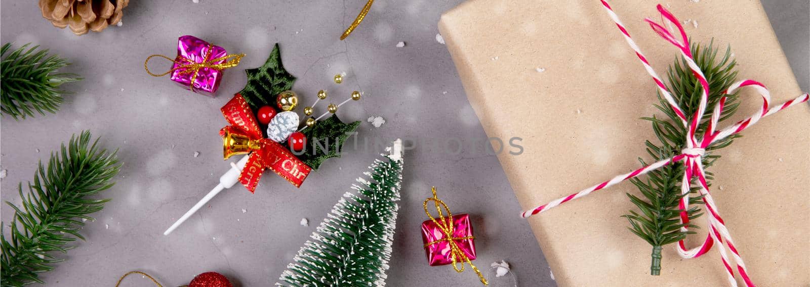 Christmas holiday composition with gift box and snow decoration, new year and xmas or anniversary with presents on cement floor background in season, top view or flat lay, copy space, banner website.