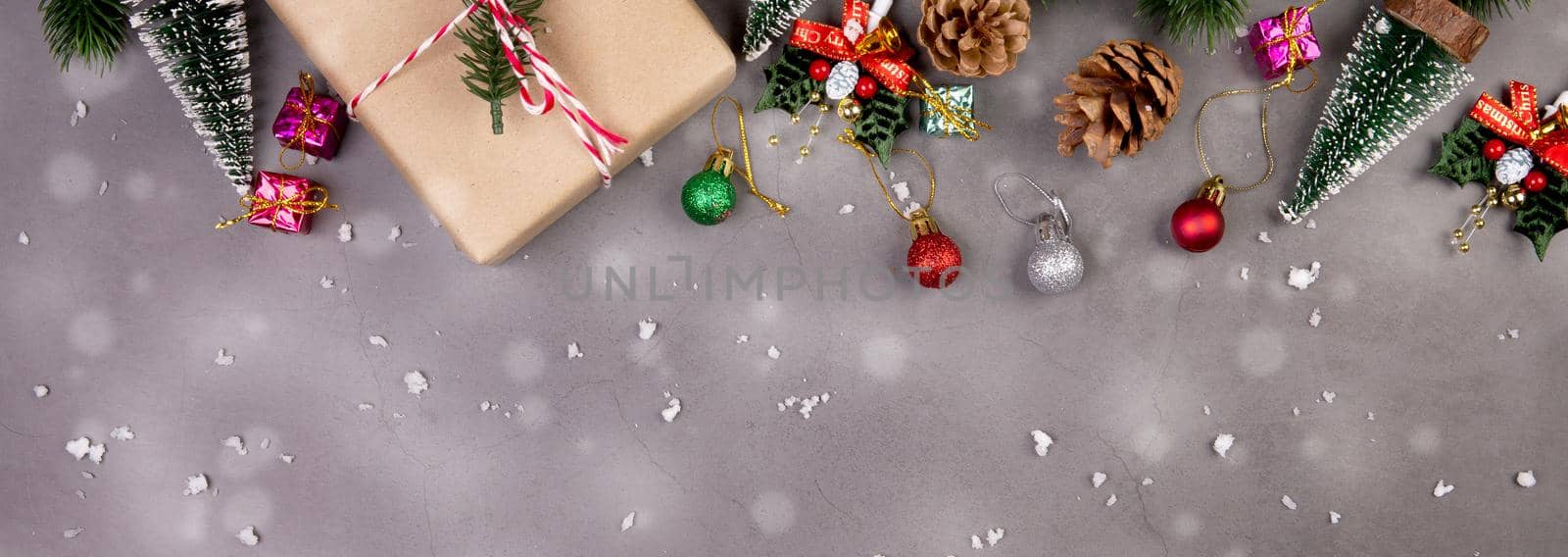 Christmas holiday composition with gift box and snow decoration, new year and xmas or anniversary with presents on cement floor background in season, top view or flat lay, copy space, banner website.