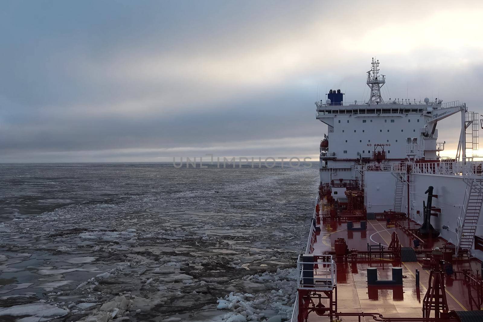 The feed of a ship sailing in the Arctic. Landscape of the Arctic from the deck of the tanker.