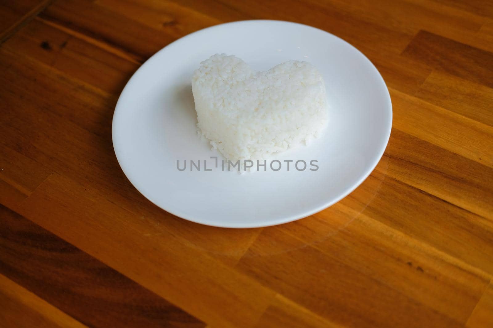 heart shaped steamed rice in white plate serving in restaurant