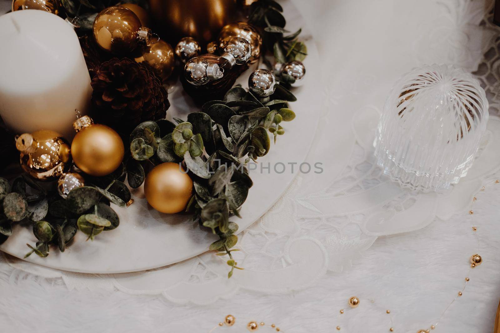 green leaves and christmas balls. festive ornament decoration. candle, conifer cone
