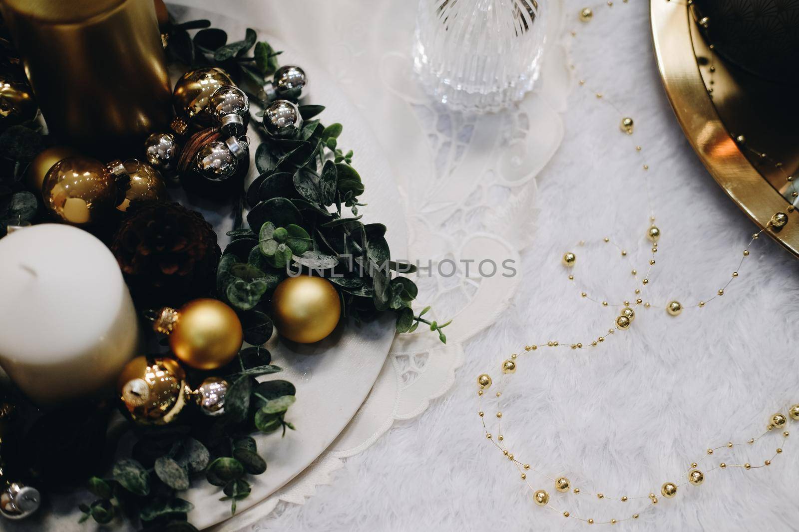 green leaves and christmas balls. festive ornament decoration. candle, conifer cone