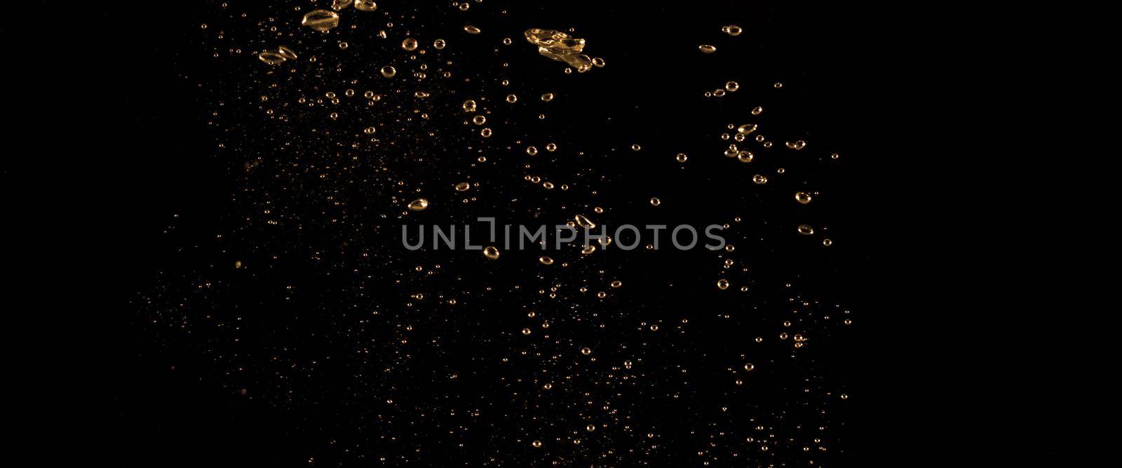 Close up images of oil bubbles from diesel gasoline splashing and floating up to the air on black background for represent power of fuel liquid that active and powerful.