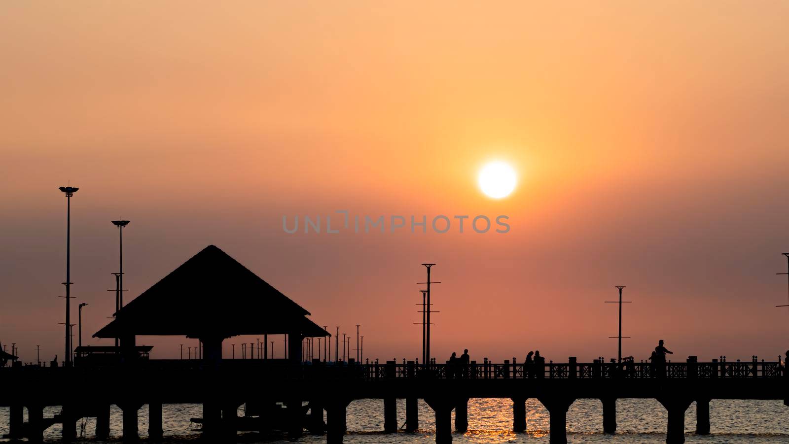 Bangsan Chonburi Thailand jetty and sunset. At Bangsan beach. Ao Thai Ocean. Beautiful sunset landscape, wooden shore jetty and colorful sky and cloud. Artistic beach sunset under wonderful sky. Recreation concept.