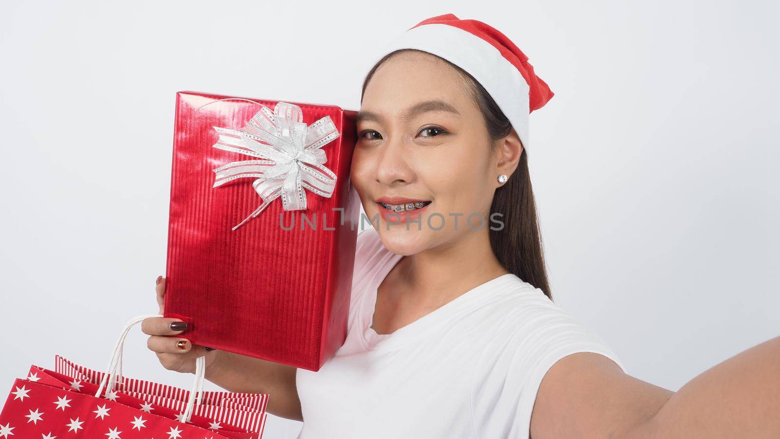 Girl hold gift box make selfie or video online with x-mas christmas prop accessories by gnepphoto