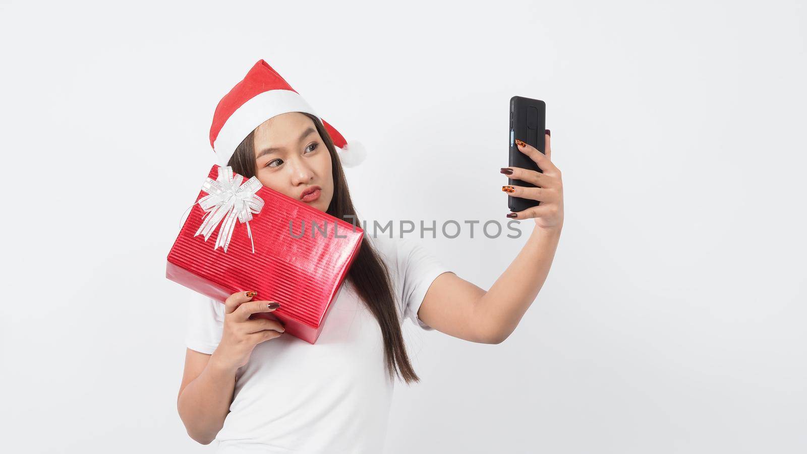 Girl hold gift box make selfie or video online with x-mas christmas prop accessories by gnepphoto