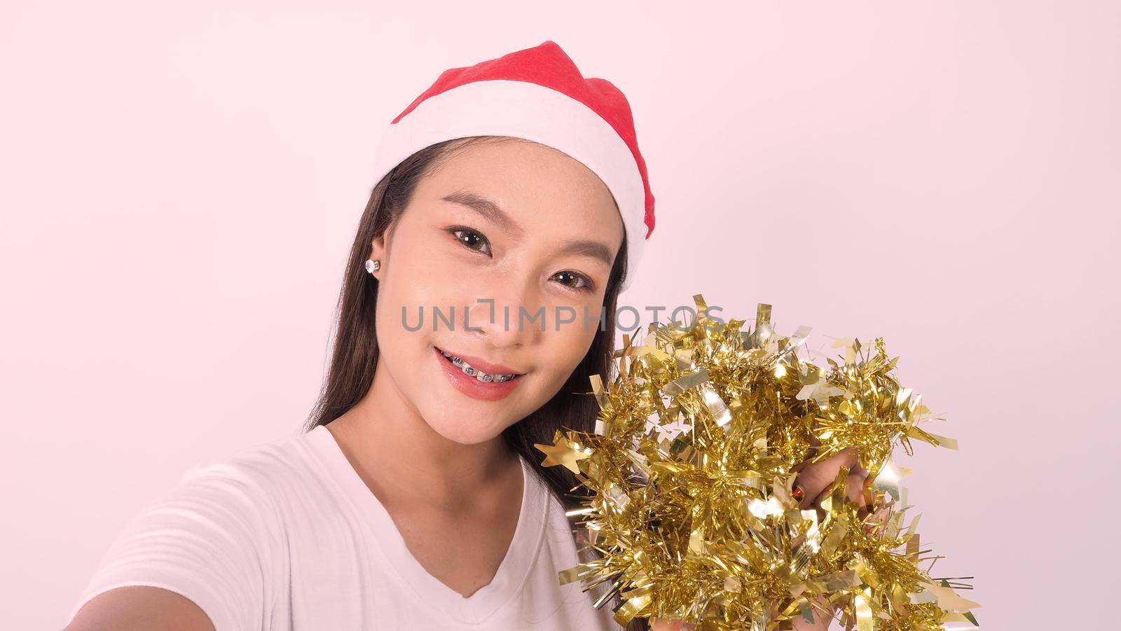 Girl hold gift box make selfie or video online with x-mas christmas prop accessories by gnepphoto