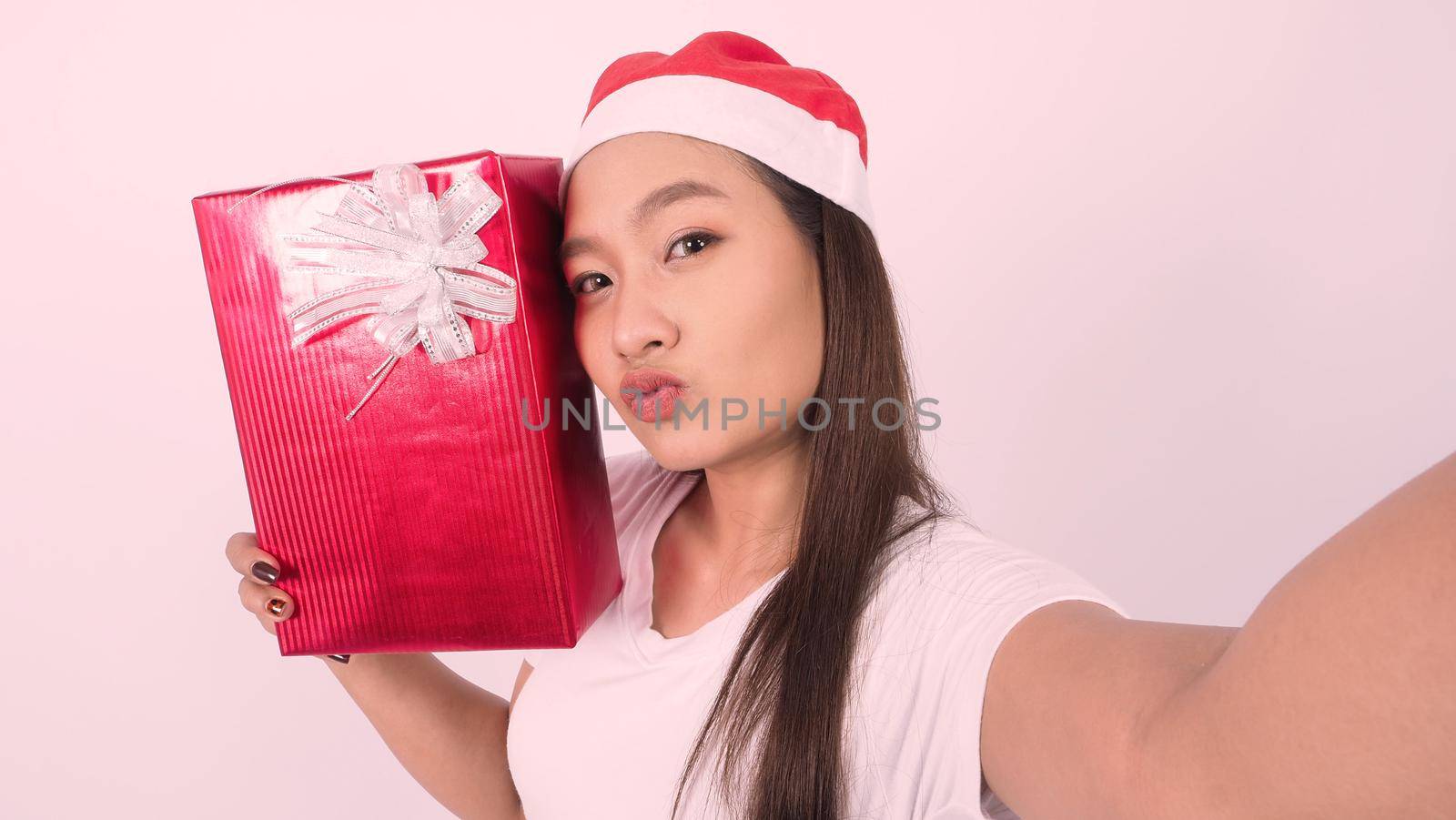 Girl hold gift box make selfie or video online with x-mas christmas prop accessories by gnepphoto