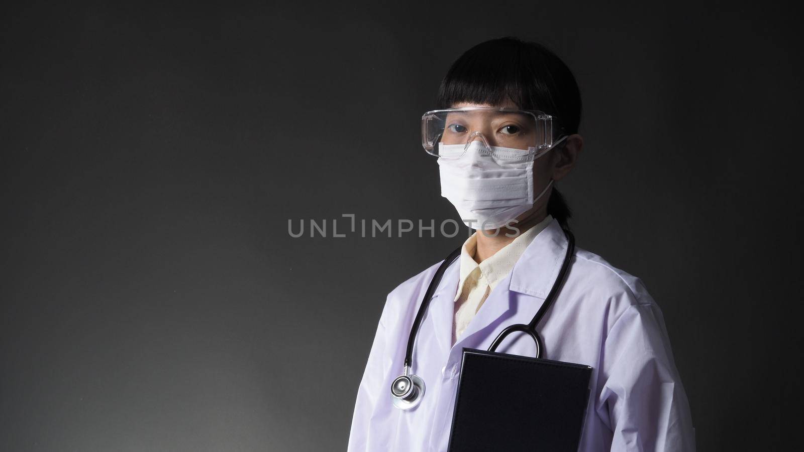 Doctor Wearing Medical Mask and clear goggles or glasses  by gnepphoto