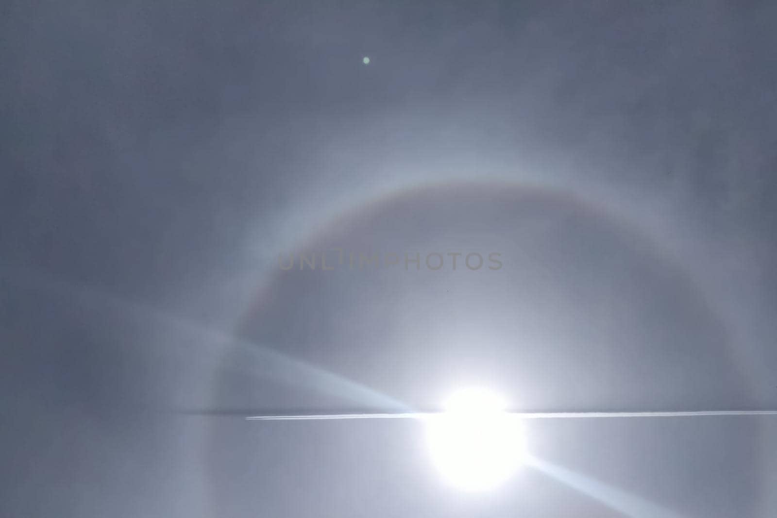 The plane flies through the halo. phenomenon of halo in the sky. A rare natural phenomenon. Three halo suns. by DePo