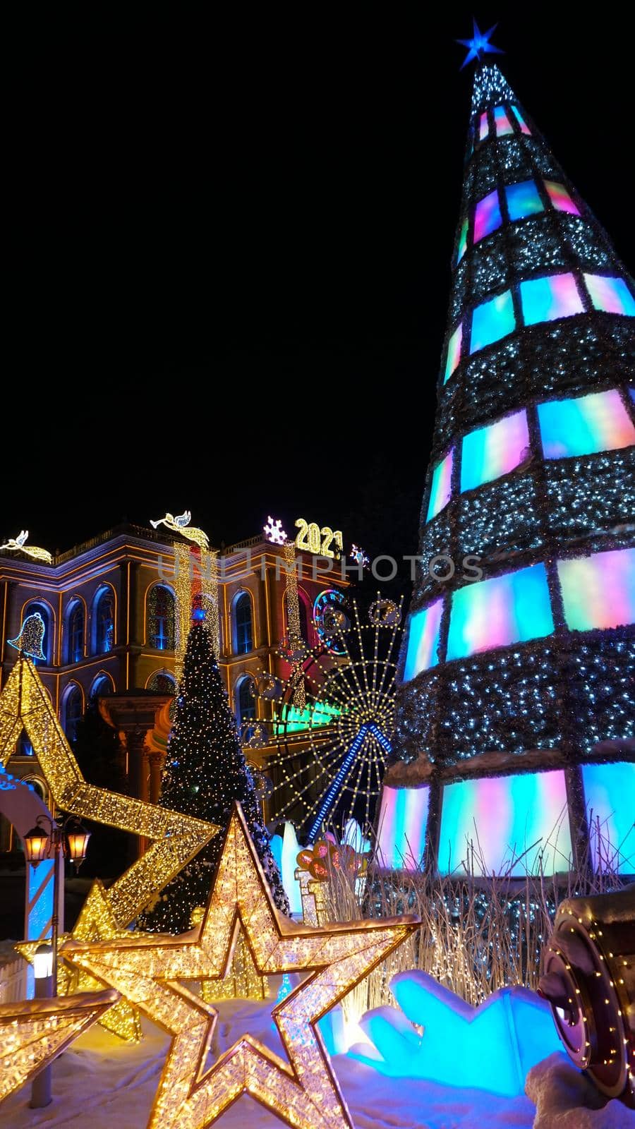 The city is decorated for Christmas and new year. Buildings, garlands, Christmas trees, fences and the square glow with different lights. People relax, enjoy the winter and holiday. Almaty, Kazakhstan