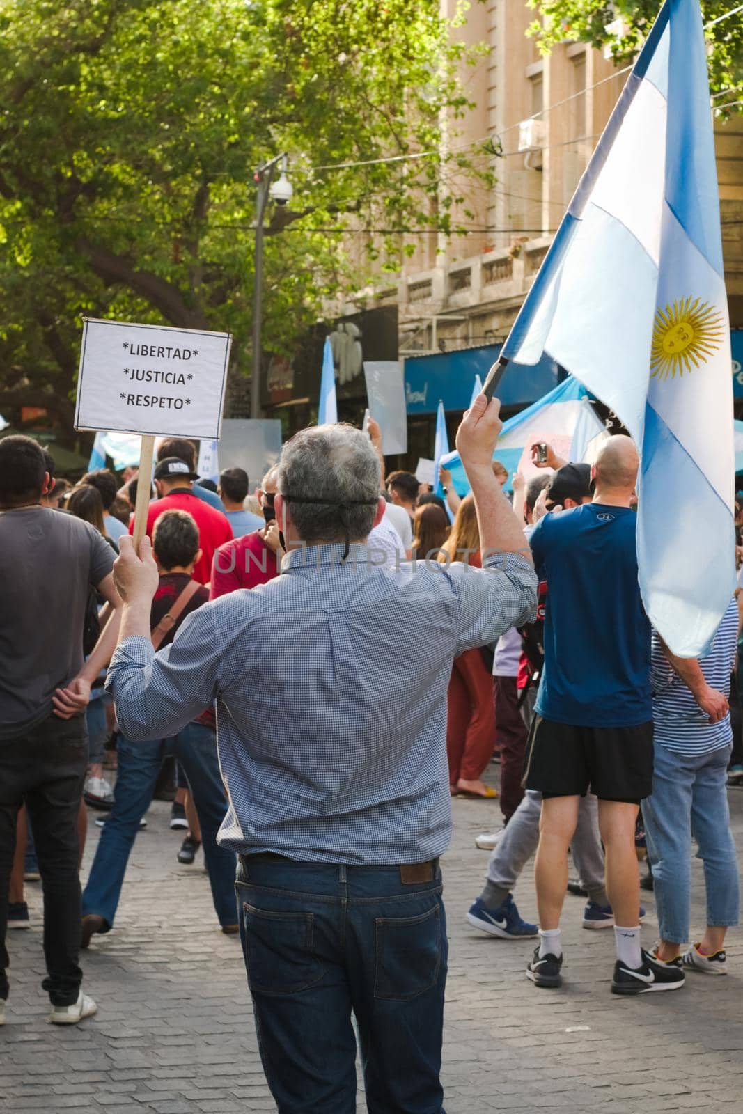 2020-10-12, Mendoza, Argentina: During a protest against the national government, a man holds a sign the reads "Freedom. Justice. Respect." by hernan_hyper