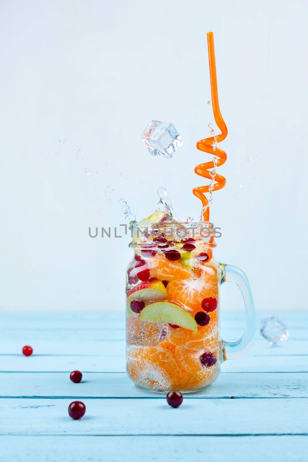 lemonade with cranberry and citrus on blue backgrounds with a splash by sashokddt