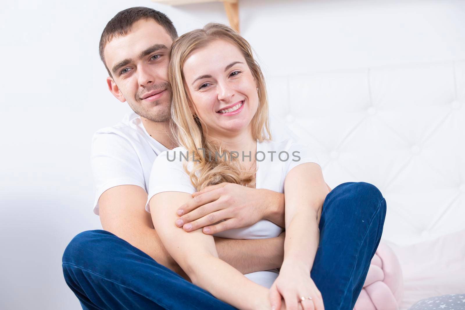 Portrait of a beautiful couple in jeans.Young man and woman hugging. Lovers by Sviatlana