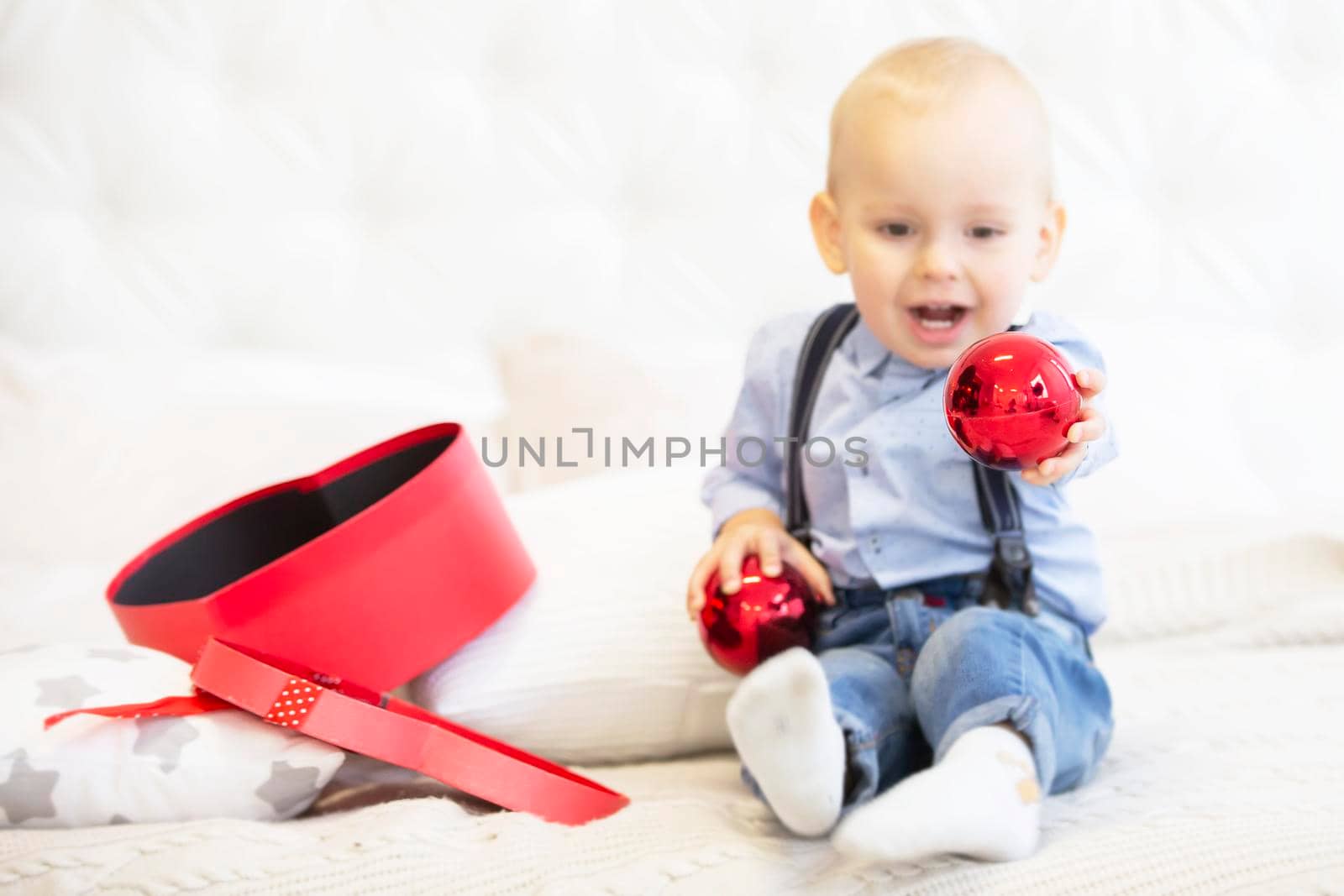 Blurred child holds a bright Christmas toy.