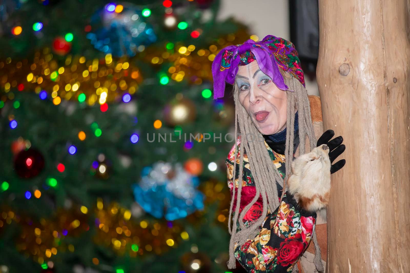 Baba Yaga on the background of the Christmas tree.
