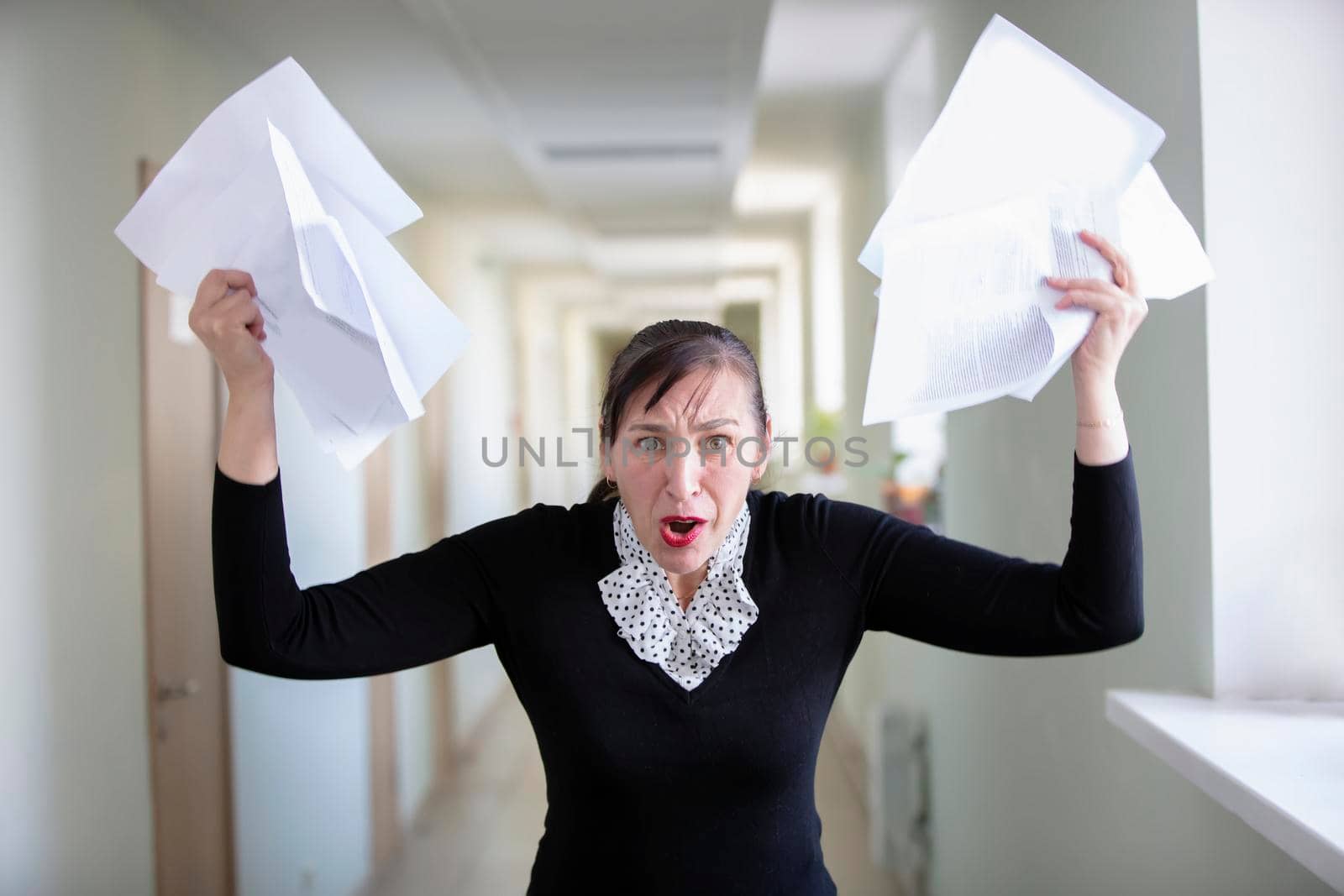 Office worker in stress. Uneven woman scatters paper.