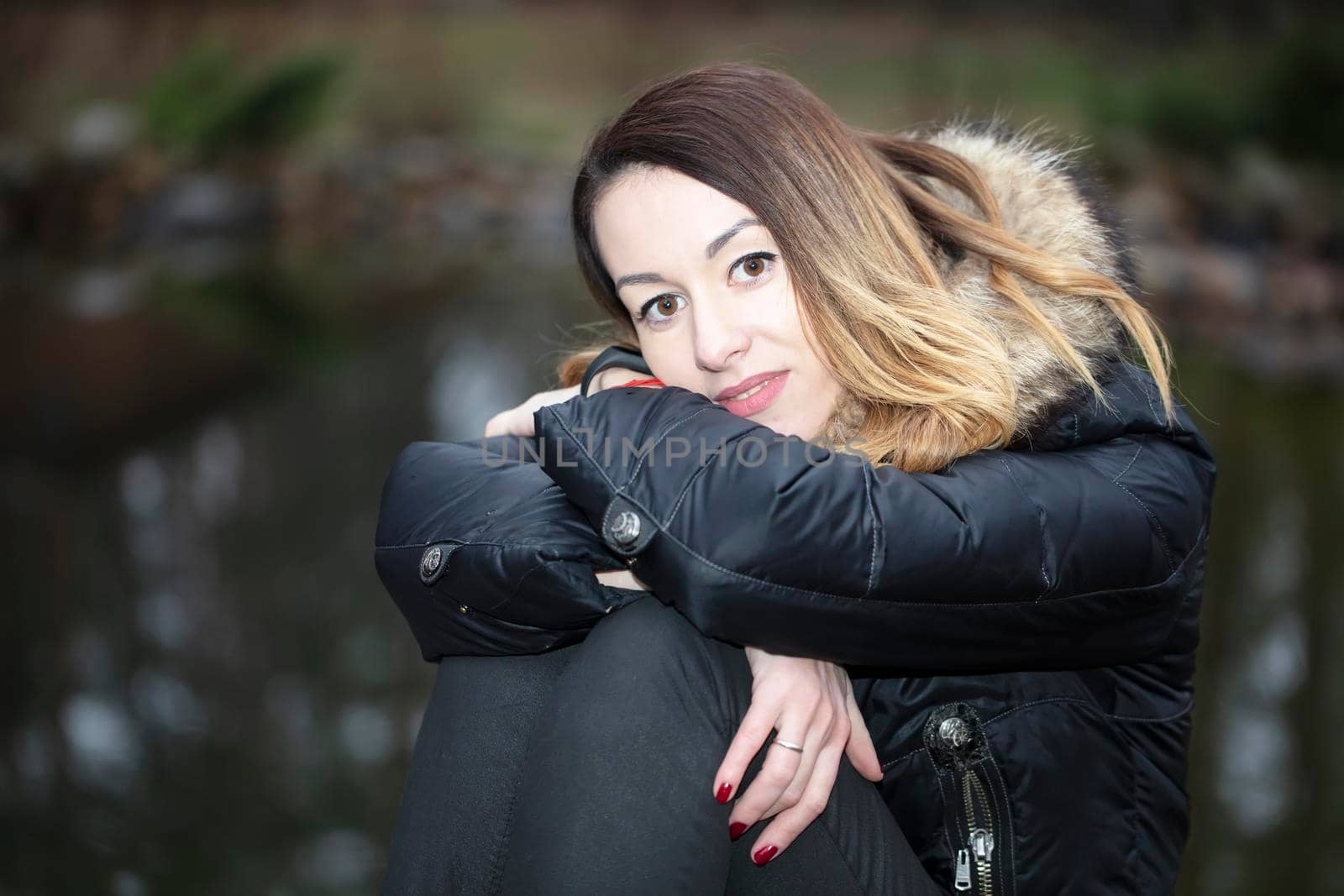 Woman in a jacket on a background of nature.