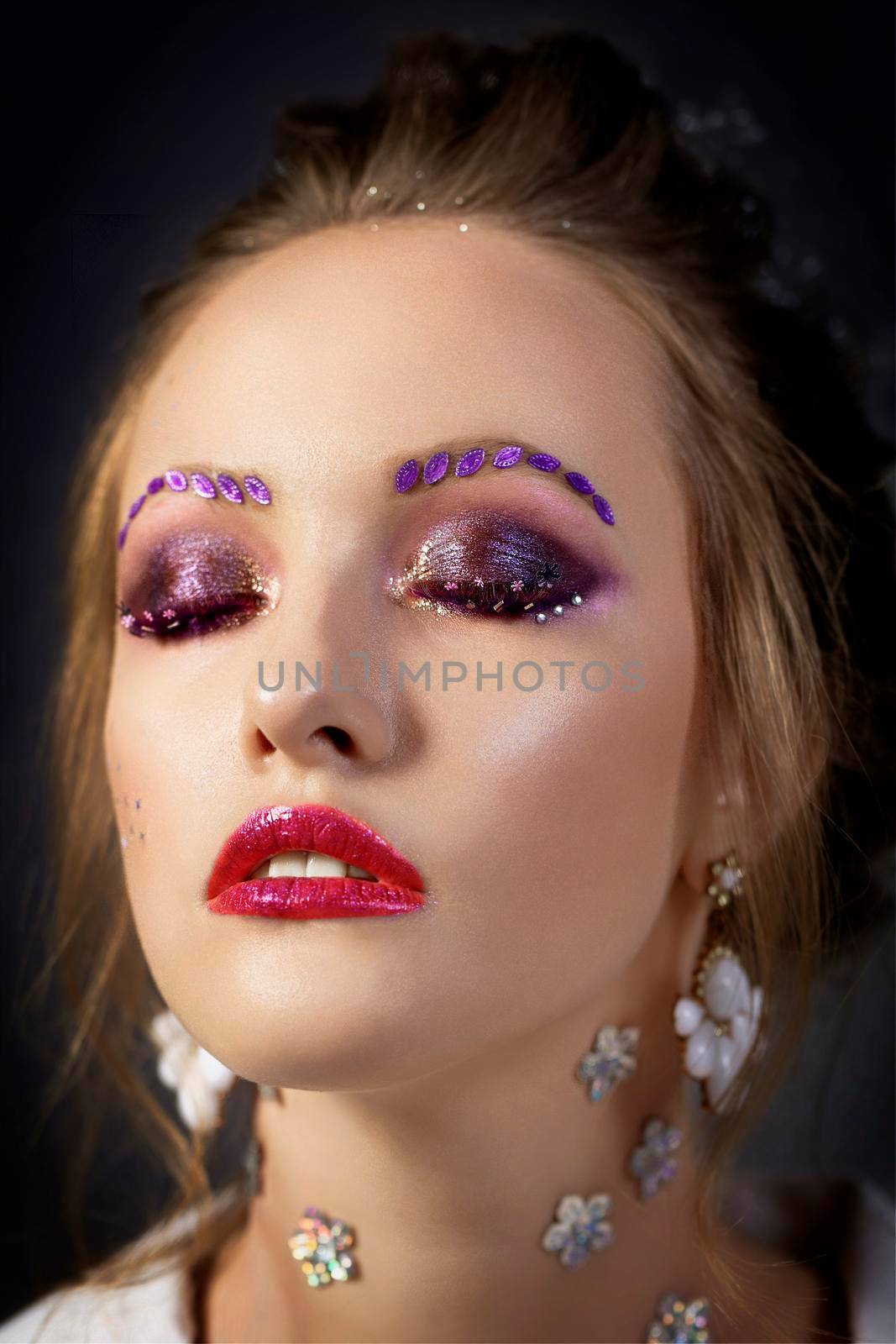 Model girl with bright makeup with eyes closed. Fashion makeup.Face with red lips.