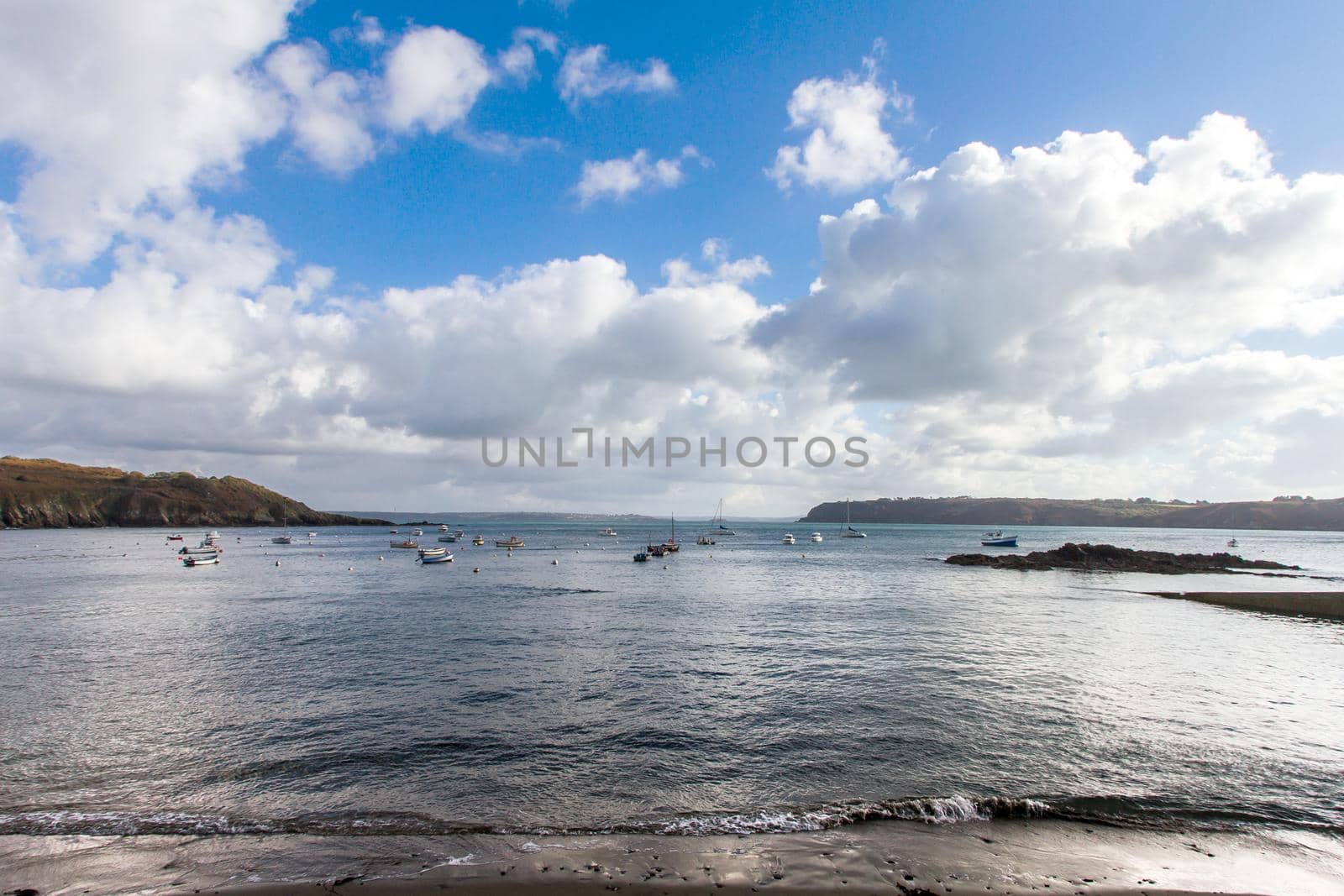 Clouds over the bay. Sea bay with boats. Boats in the bay on a cloudy day.