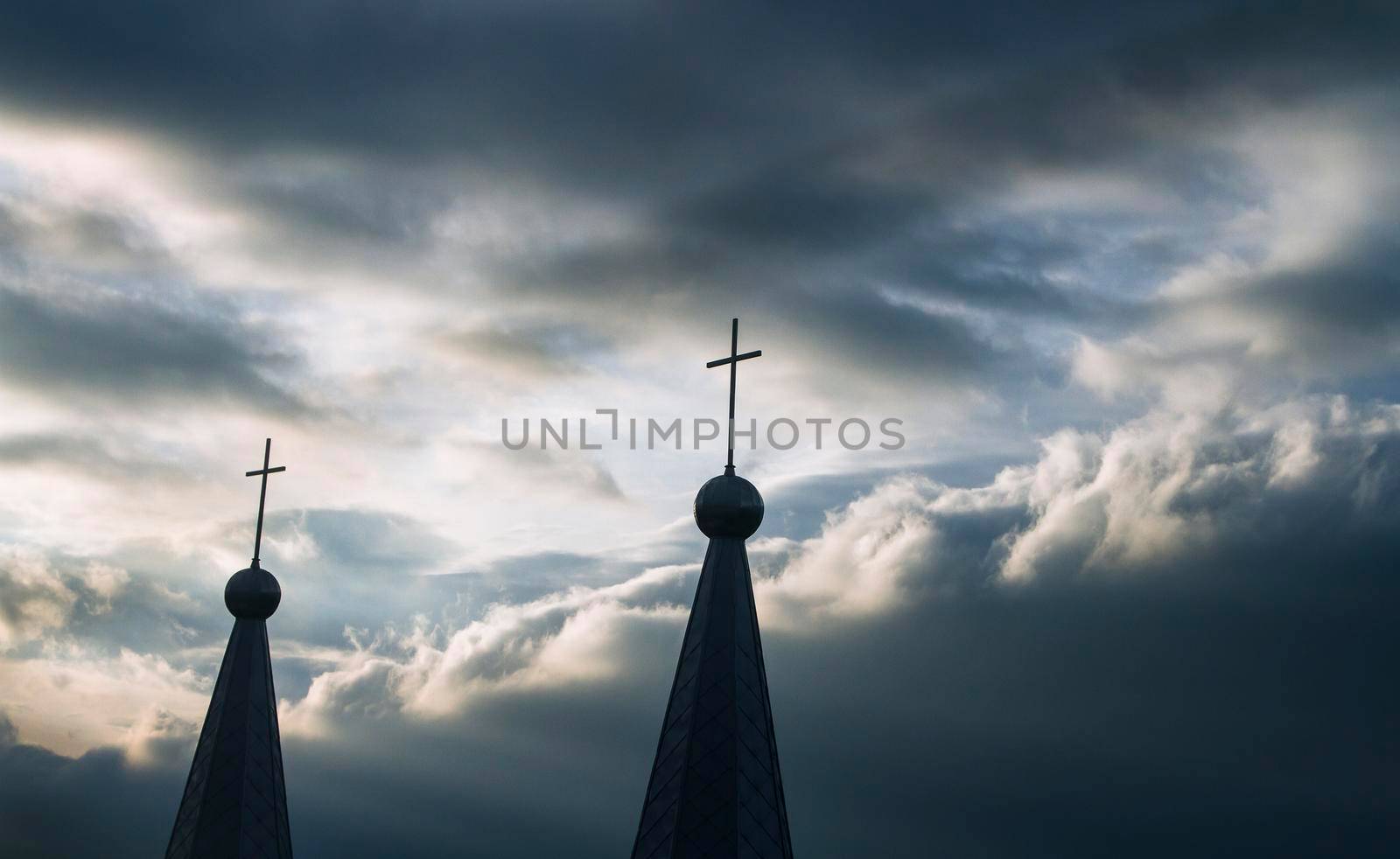 Church on a cloudy day. Cross against the sky. The domes of the church.