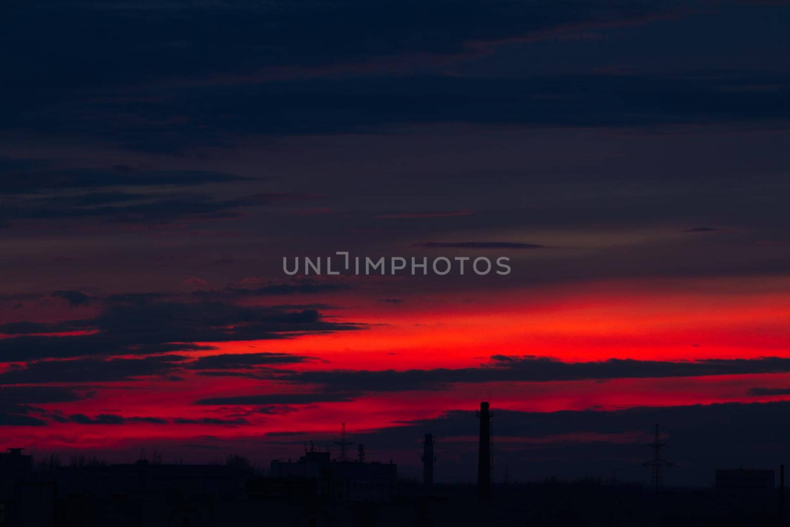 Red blue clouds at sunset. by Jannetta