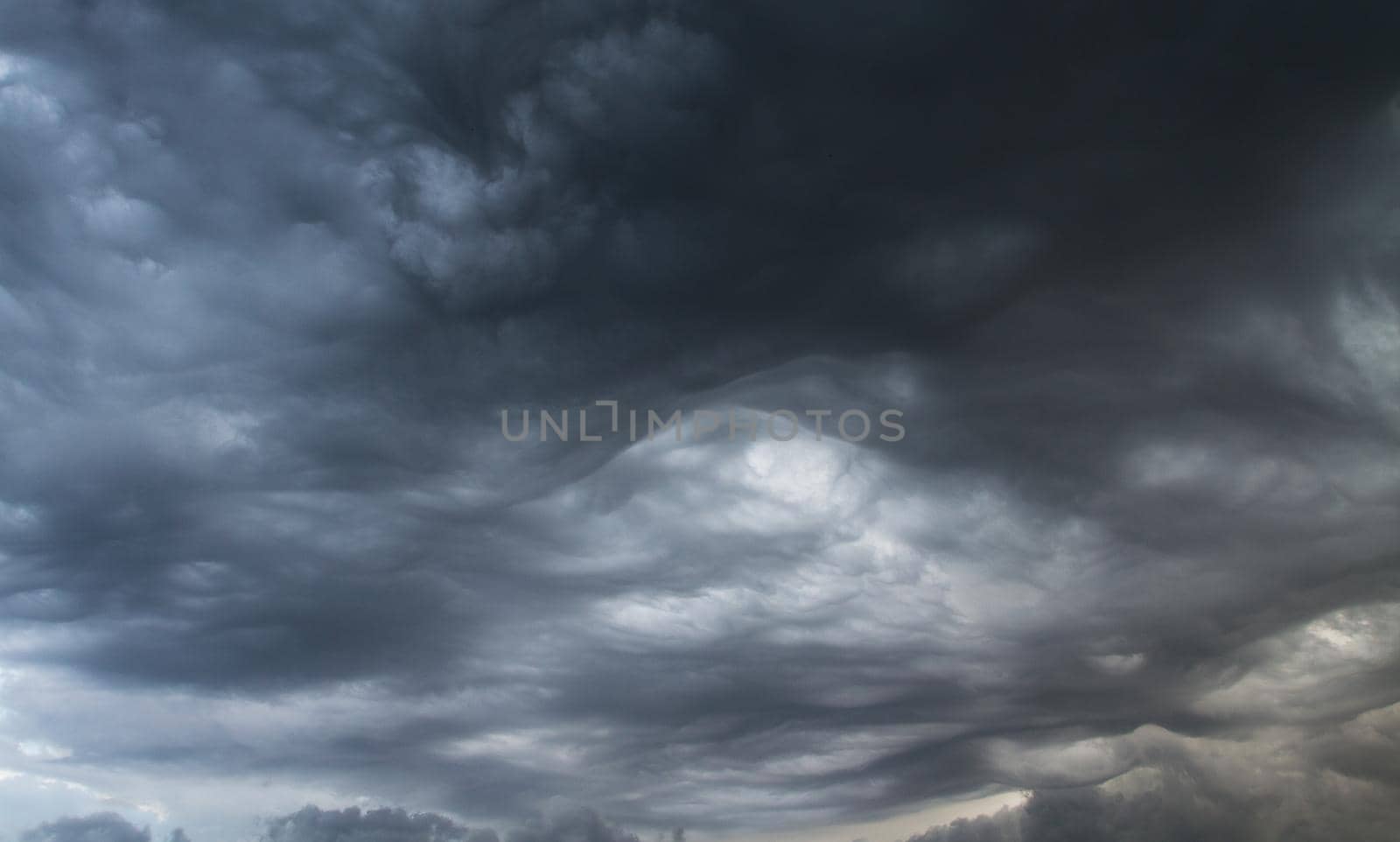 Thunderclouds. Before the storm. Storm clouds. Waves and swirls of gray clouds. by Jannetta