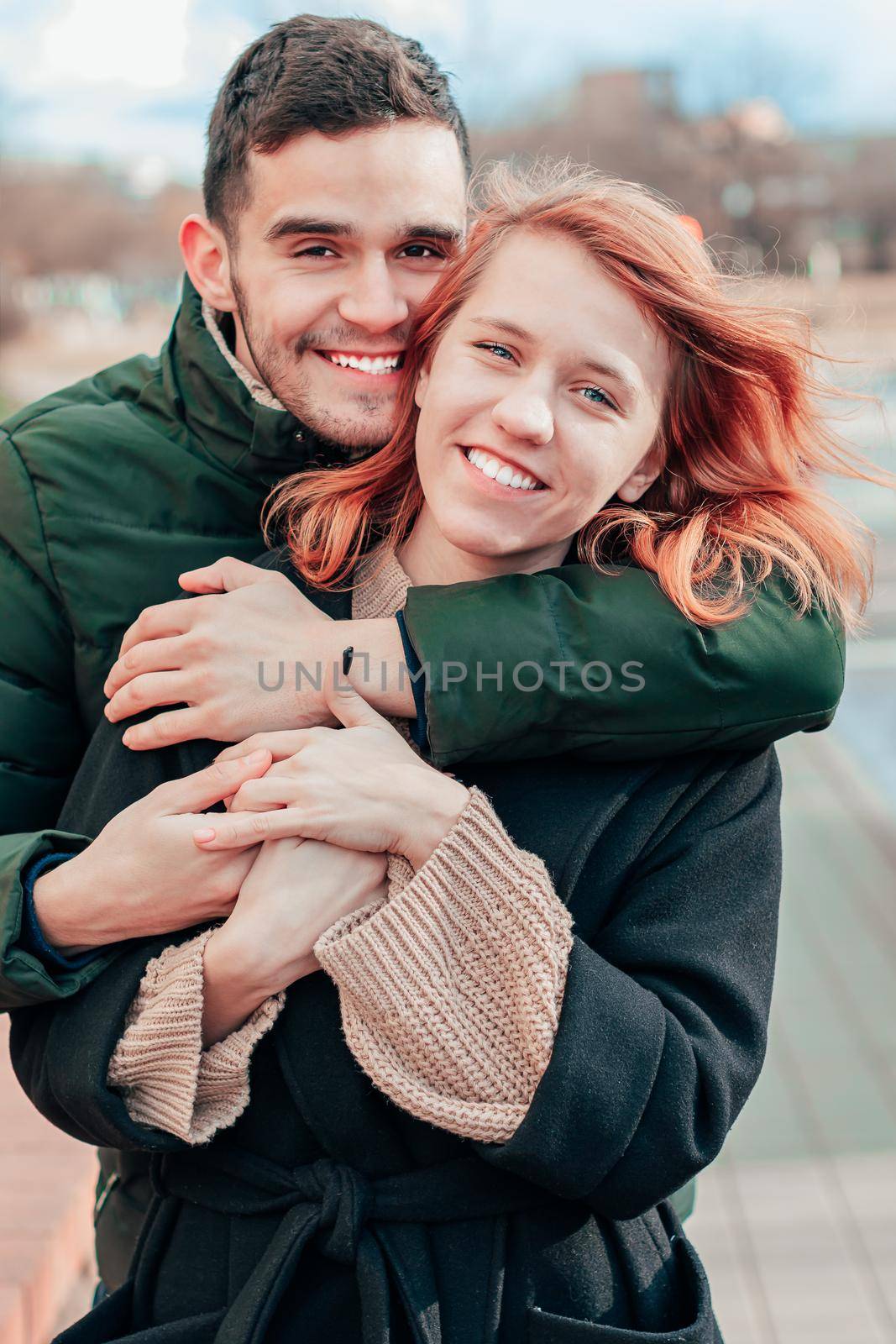 Happy Loving Couple Smiling and Hugging on the Street. Two Happy People Love Story - Medium Shot Portrait