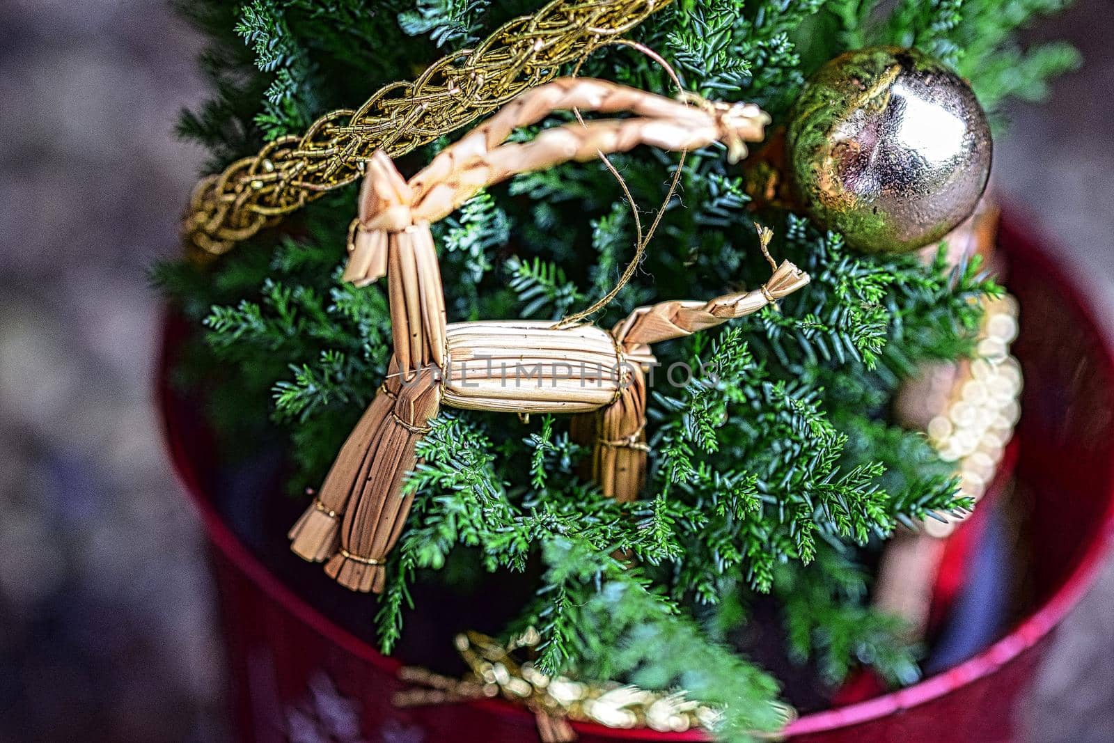 Close up of a straw horse at a small decorated christmas tree